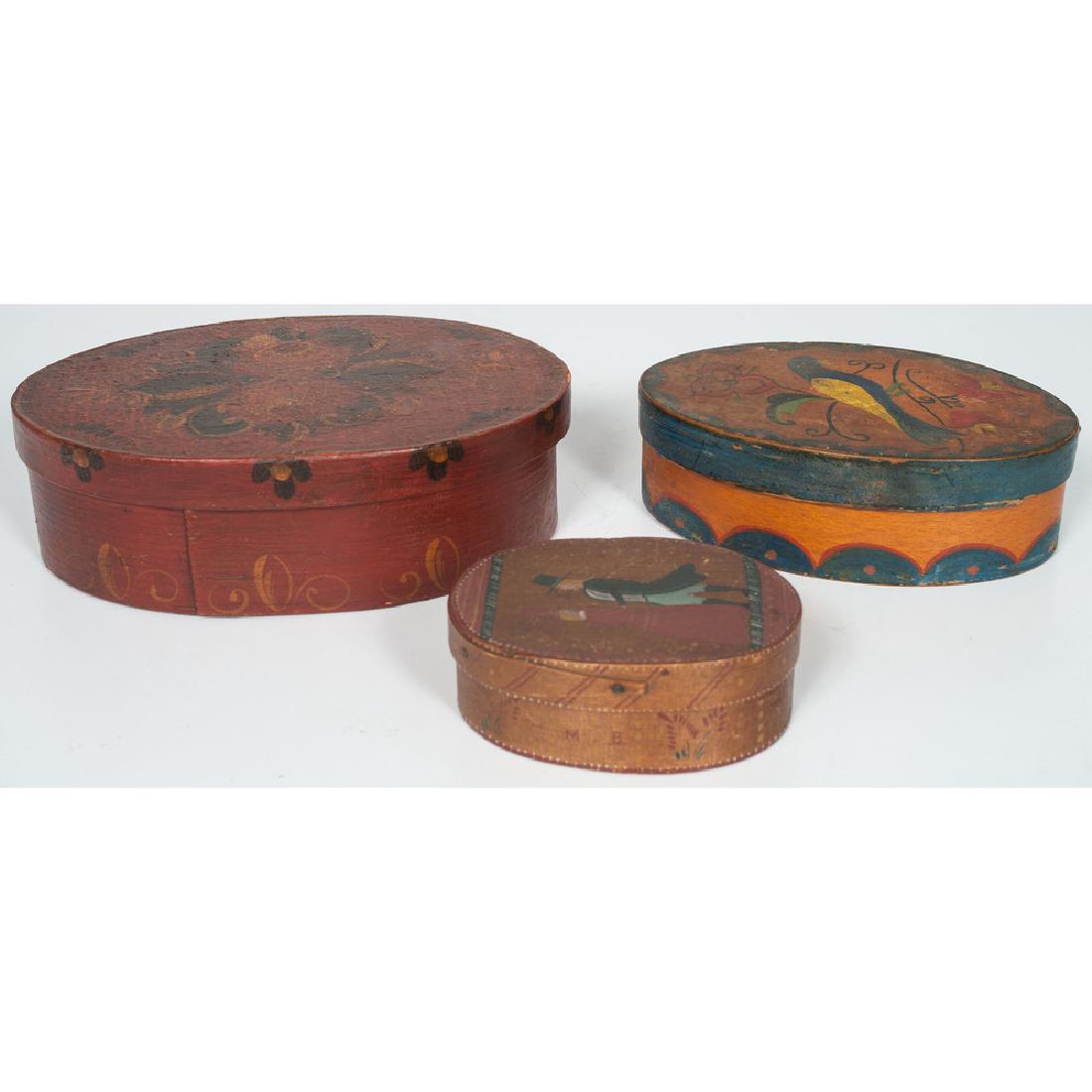 Painted Oval Pantry Boxes: American. Three graduated pantry boxes decorated with avian, floral and colonial figural motifs; largest ht. 2.5, lg. 8.25, wd. 5.5 in.