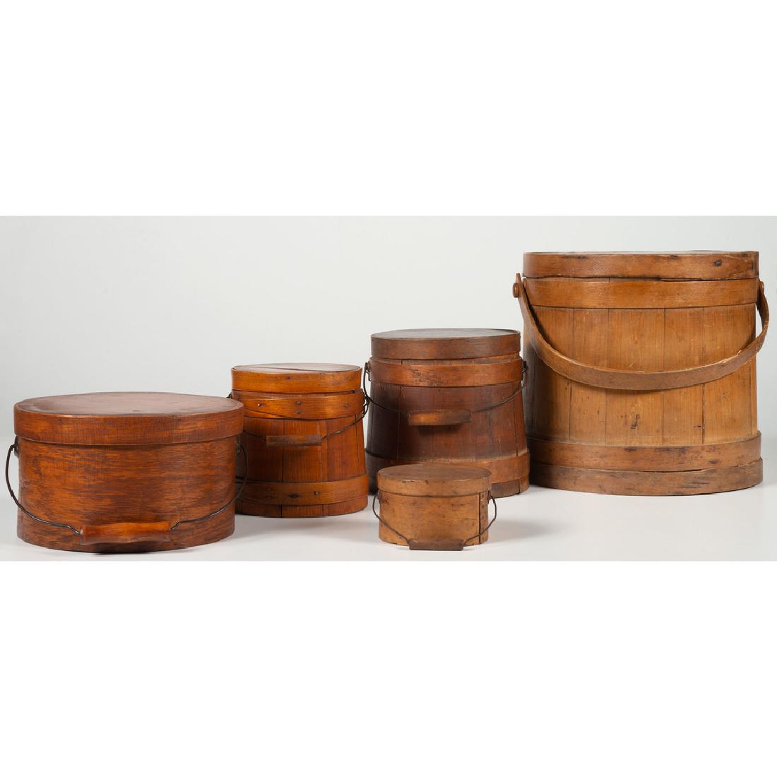 Firkins and Bail-Handled Pantry Boxes: American, 19th century. Three wooden firkins, the largest having a bentwood handle and the smaller two having bail handles, and two round bentwood pantry boxes with bail handles; largest firkin ht. 11