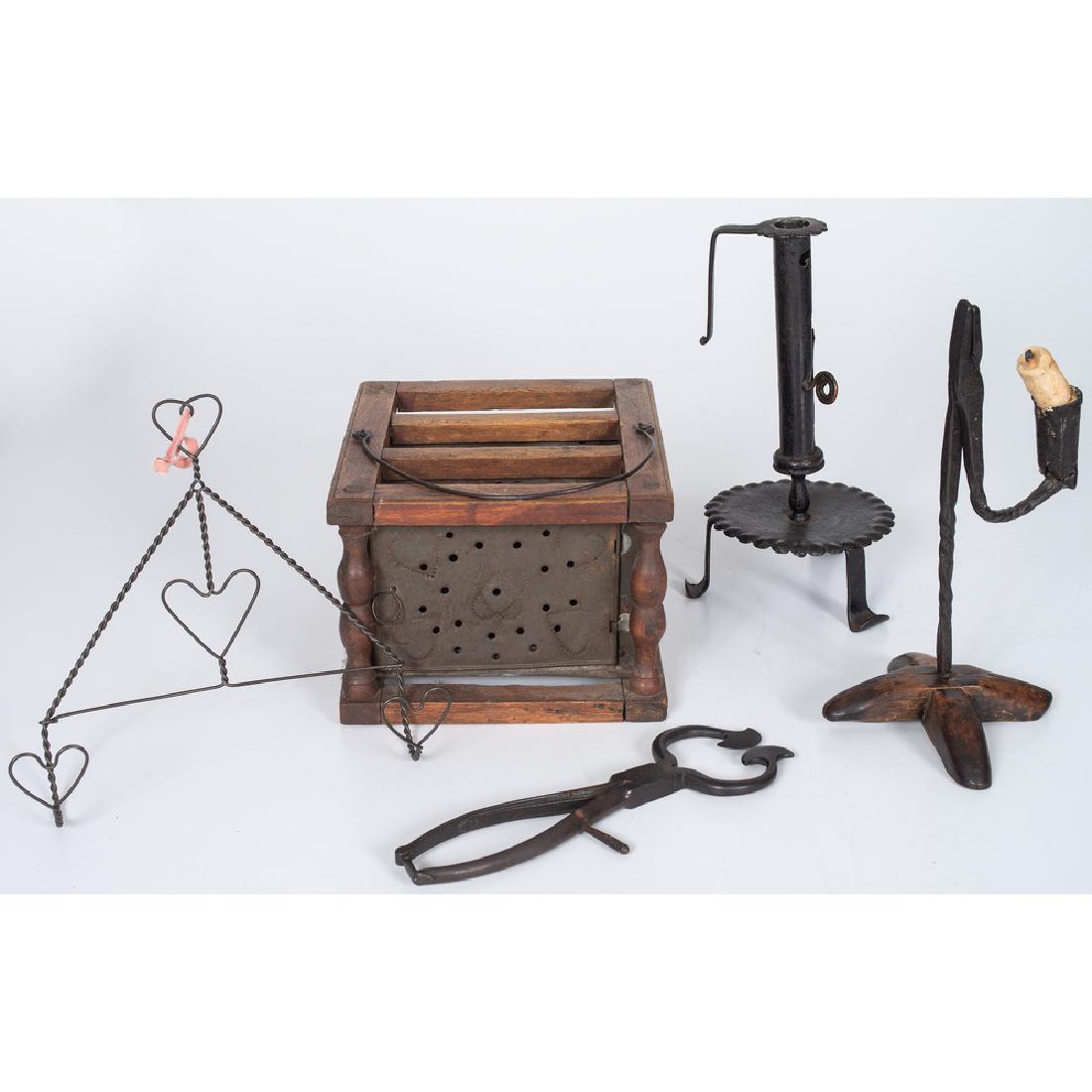 Early English and American Lighting, Plus: 18th-19th century. An English iron rush light with wooden cross base and an American iron candlestick with scalloped and tripod base, PLUS a wooden and punched tin foot warmer, iron sugar nips, and a 