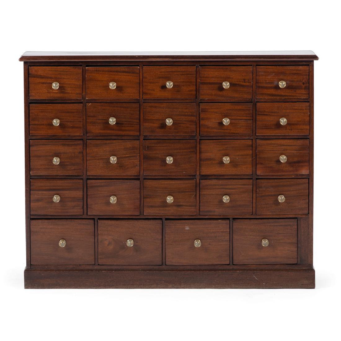 English Mahogany and Pine Spice Cabinet: English, 19th century. A spice or apothecary cabinet in mahogany with pine secondary, the molded surface above twenty-four fitted dovetailed drawers with brass pulls, rising on applied molded base; ht