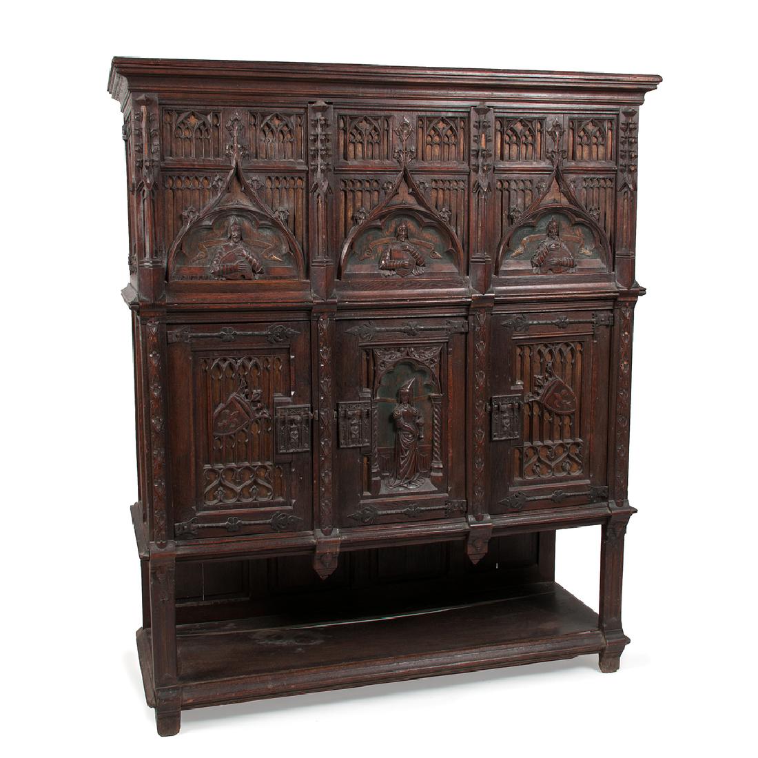 Renaissance Revival Court Cupboard: Renaissance Revival Court Cupboard Continental, late 19th century. A Renaissance Revival court cupboard in oak with iron hardware, having molded top over heavily carved case with two lead-lined side-c