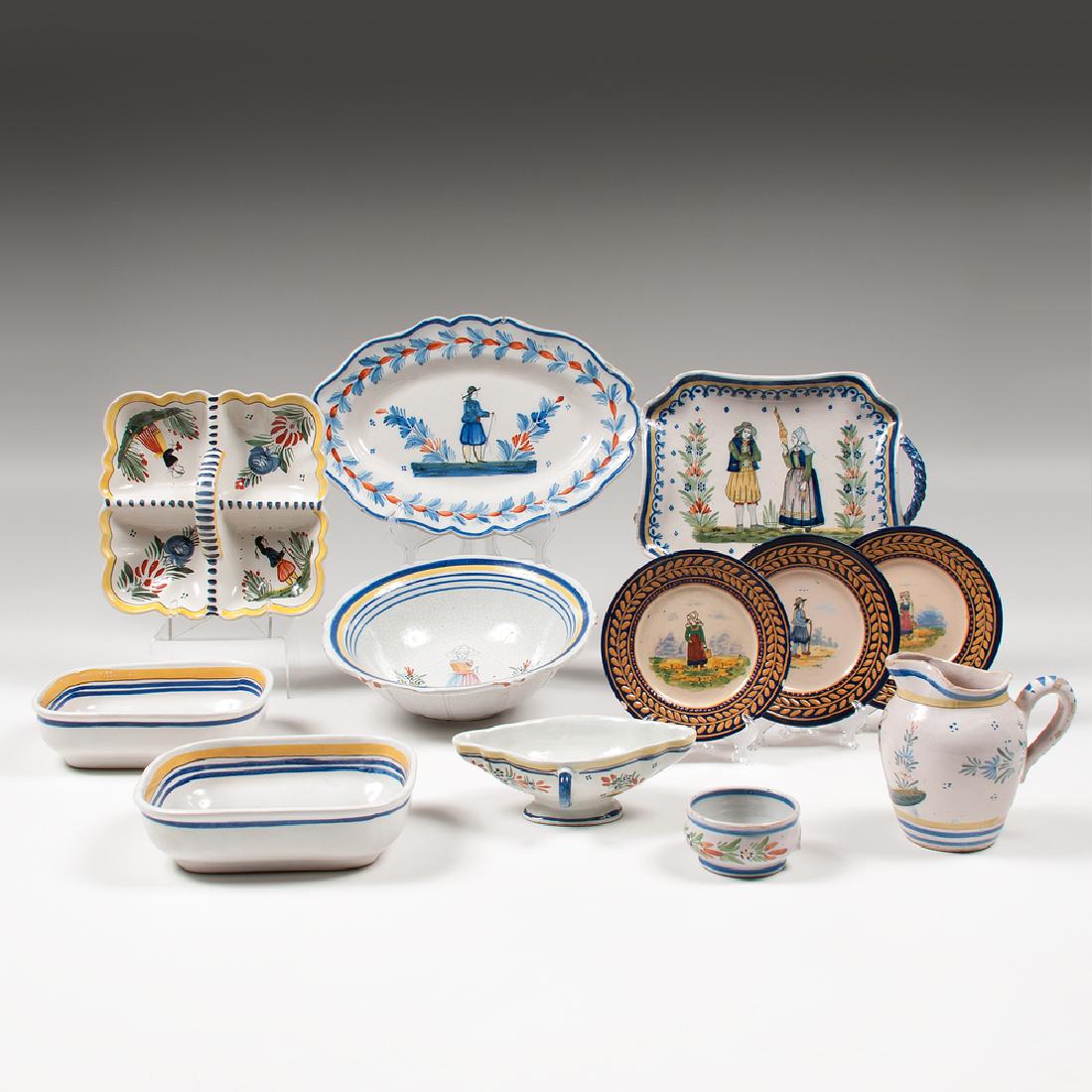 Quimper Pottery Tablewares: Quimper Pottery Tablewares French, 20th century. Twelve pieces of Quimper pottery with various designs, including one oval dish, one handled vegetable tray, one square dish with handle, three bread pl