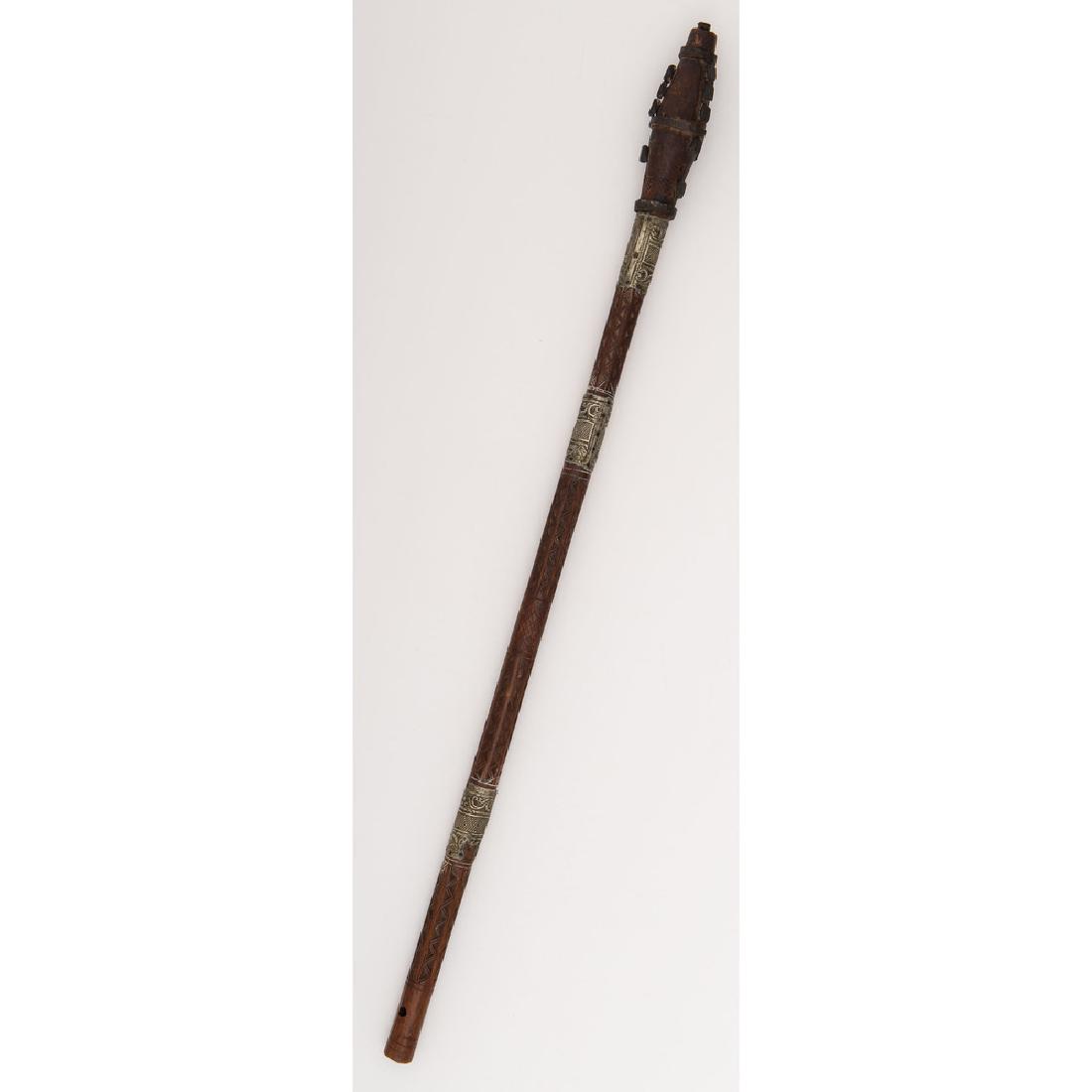 African Iron-Mounted Club: 35.25" overall length, likely of African origin. Haft carved in geometric designs with applied sheet metal bands. Head fitted with iron studs.