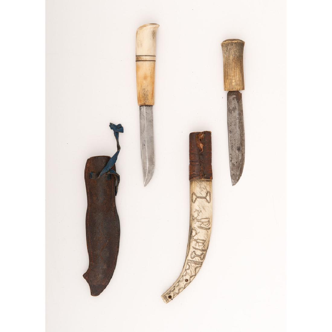 Lot of Two Danish Knives: First knife's handle is composed of deer antler. Scabbard stamped with sled and reindeer. Illegible owner's name inscribed on blade. Second knife's handle is composed of deer antler. Scabbard is compo