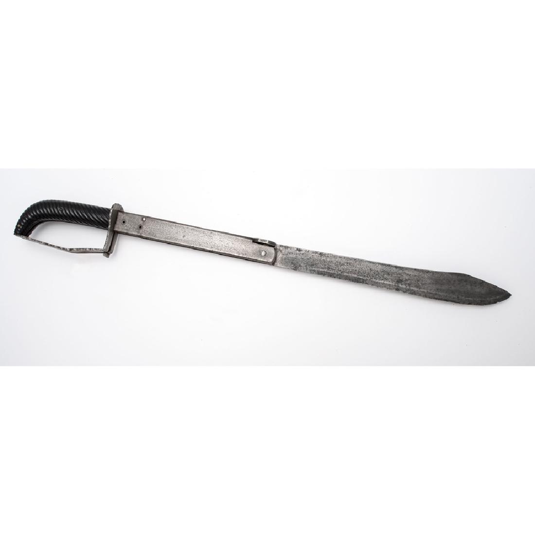 Folding Cutlass: 11" single edged blade, overall length when open 23.5", overall length when closed 12.5". Steel knuckle-bow with grooved wood grip. Blade marked "ARNOULD NAMUR". Likely Belgian.