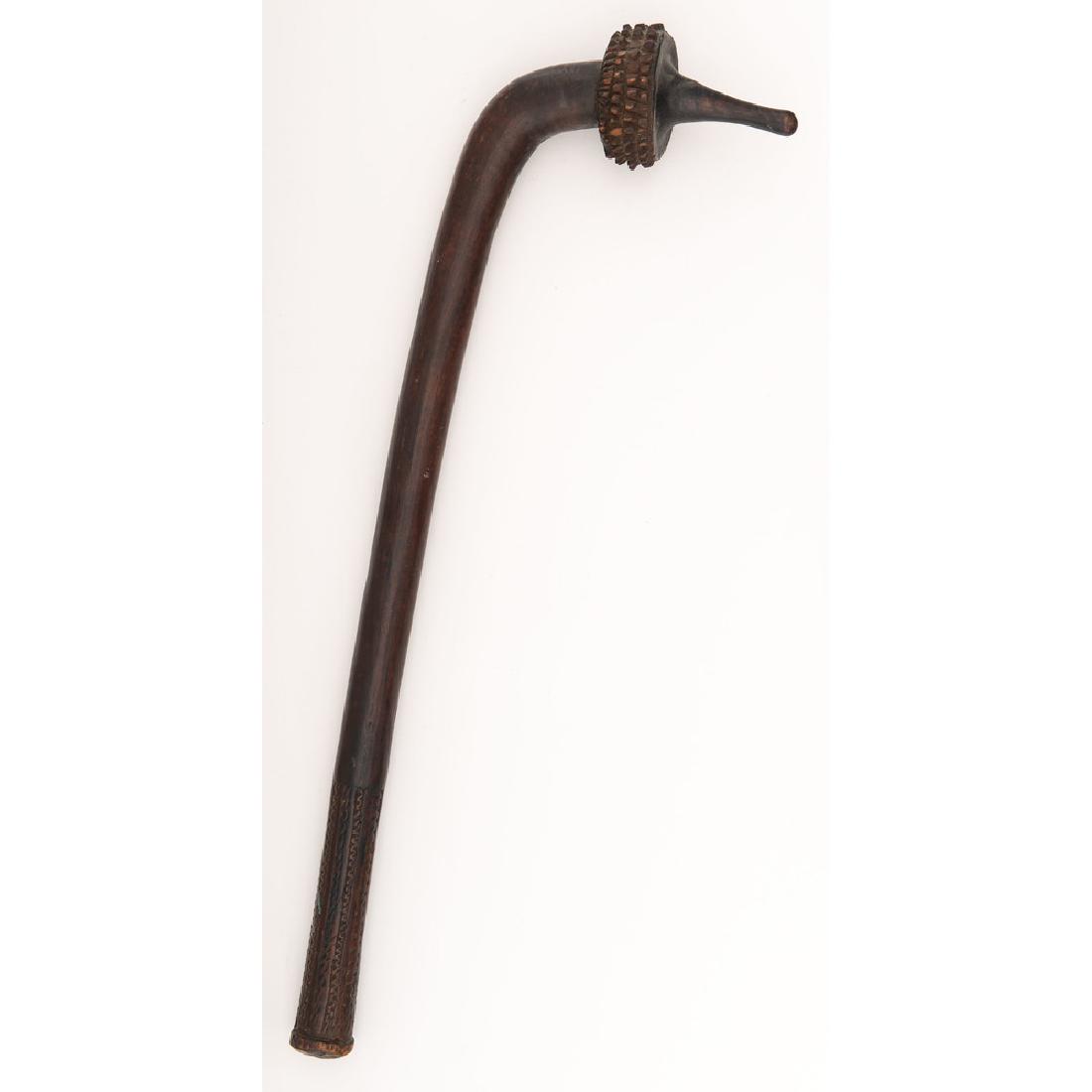 Fijian War Club, Totokia: Ca. late 18th-early 19th Century. 31" overall length with rounded beak and carved spines. Bottom of haft shows geometric angled wave carving around circumference.