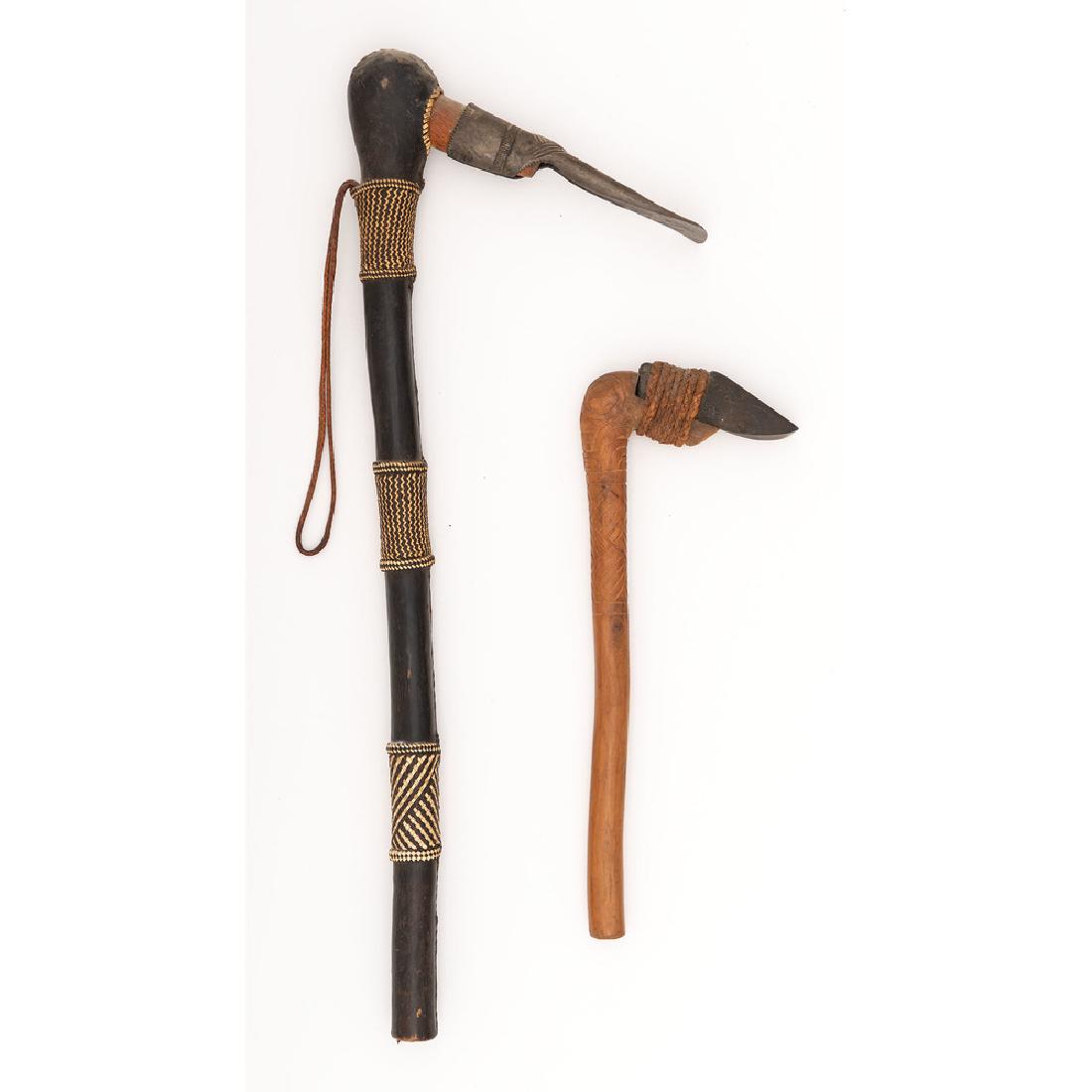 Lot of Two Adzes: Lot includes one Hawaiian ko'i adze with 3.75" stone blade and 13" wood haft, and one African-style adze with 6.25" iron blade and 23" leather wrapped wood haft with woven ornamentation.