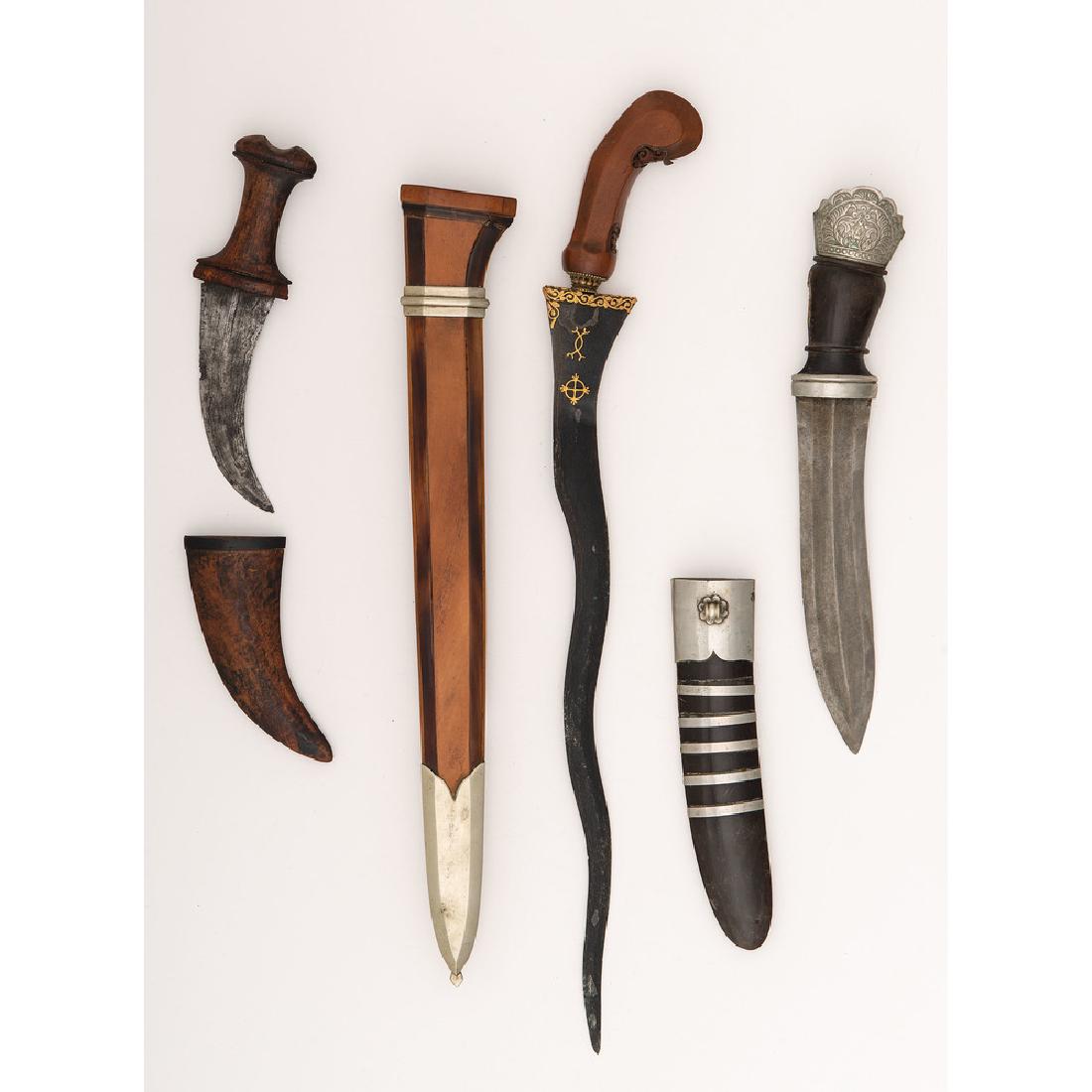 Lot of 2 Indonesian Knives and Indonesian Kris: First item is a re-shaped Kris with gilded talismanic symbols on both sides of the blade. Scabbard is a non-traditional pattern after a European style with low grade silver fittings. Second item is an