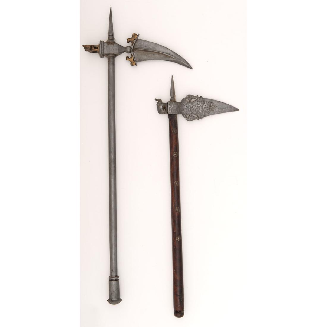 Lot of Two Indian Zaghnals: Likely 20th Century. Lot consists of two Indian zaghnal war-picks measuring 23.25" and 28.5", with wood and metal hafts, respectively. Both show elephant motifs on hammer portion.