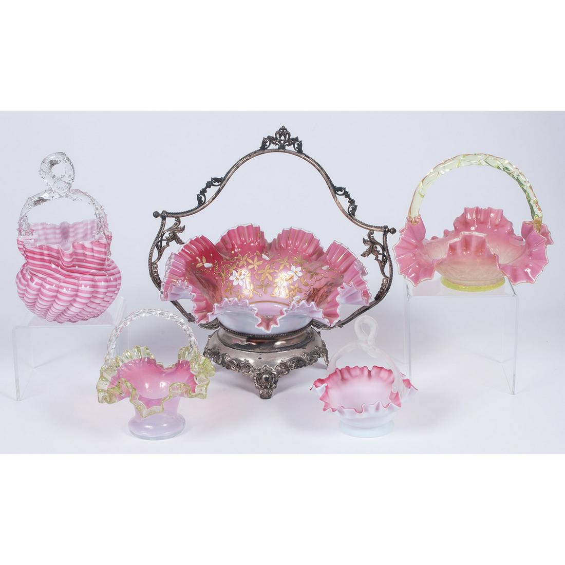 Victorian Glass Baskets: American. Five colored glass baskets, including one painted bride's basket with silverplated stand; largest ht. 12.75 in. (including stand).