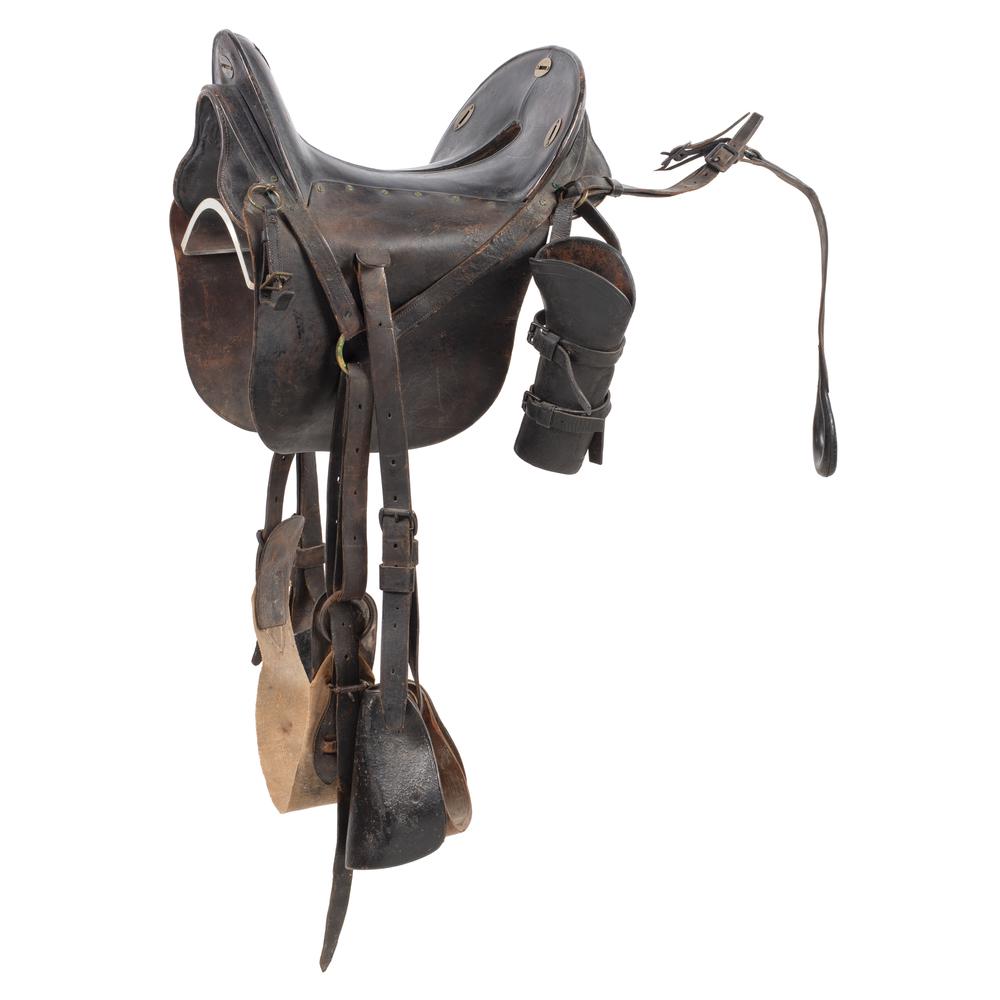 McLellan Type Saddle: Seat measures 14.25". Leather skirts with leather-hooded wood stirrups, 3.5" wide linen girth. Fitted with two carbine sockets and one carbine holster. Appears similar to early models of the "Mc