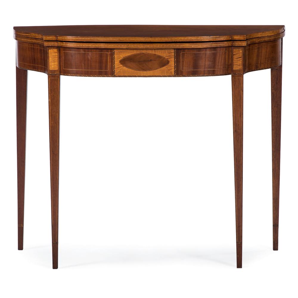 North Shore Inlaid Game Table: American, 19th century. A Federal period game table in mahogany, having a shaped fold out surface with swing leg support and perimeter inlay, the conforming apron with central oval, checker and line i