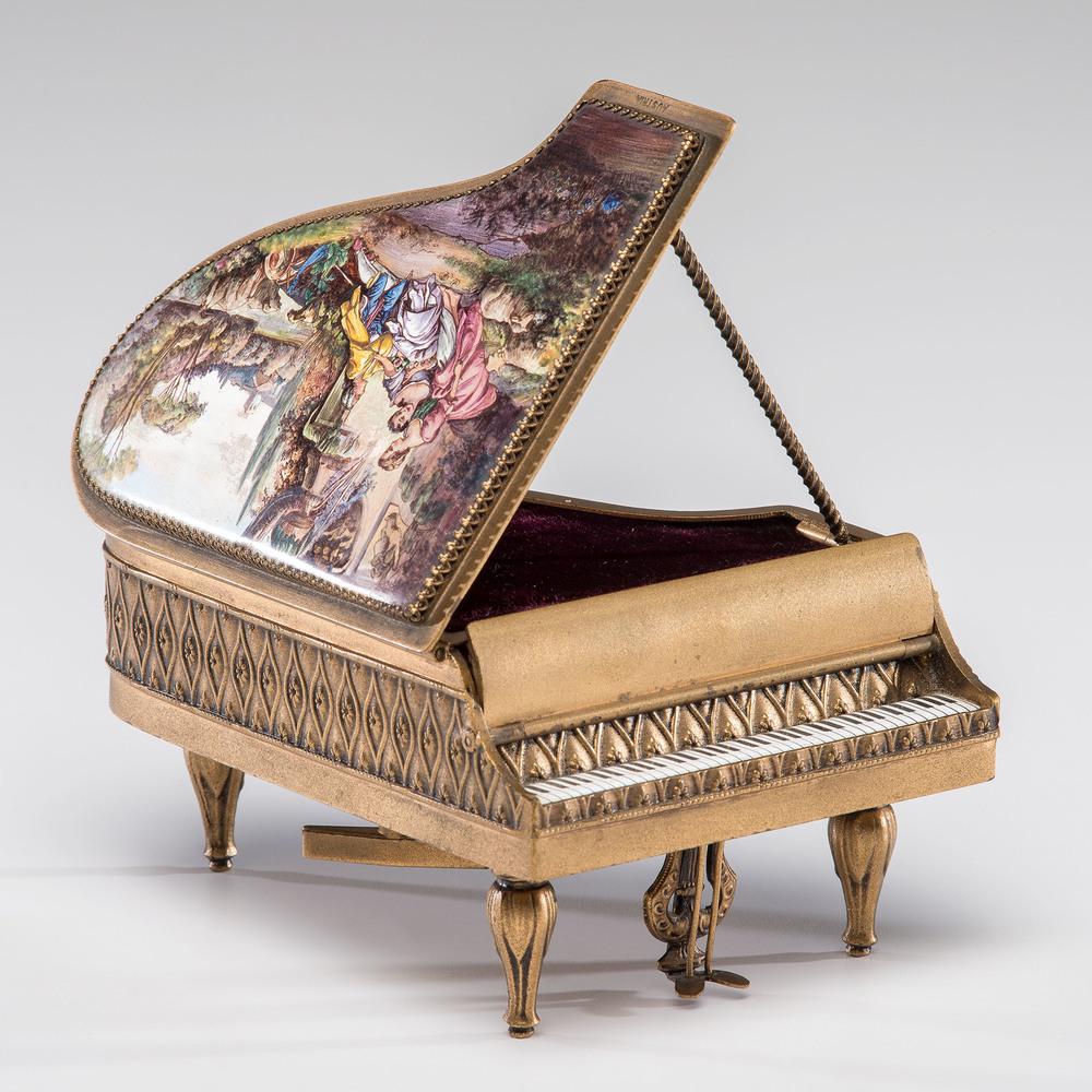 Austrian Piano Music Box: Austrian, 20th century. A miniature piano music box with painted and enamel top and fall board decorated with a pastoral courting scene and putti, opening to a velvet-lined interior, with painted pian