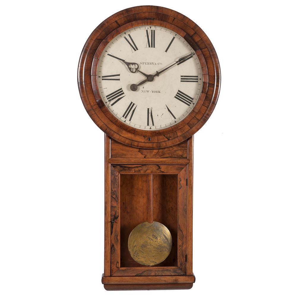 Monumental Sperry & Co. Wall Clock: American, mid-19th century. A monumental wall clock in a mahogany case, having a painted metal dial with cut out hands, labeled Sperry & Co. / New York; ht. 61.25, wd. 30.25, dp. 5.5 in.