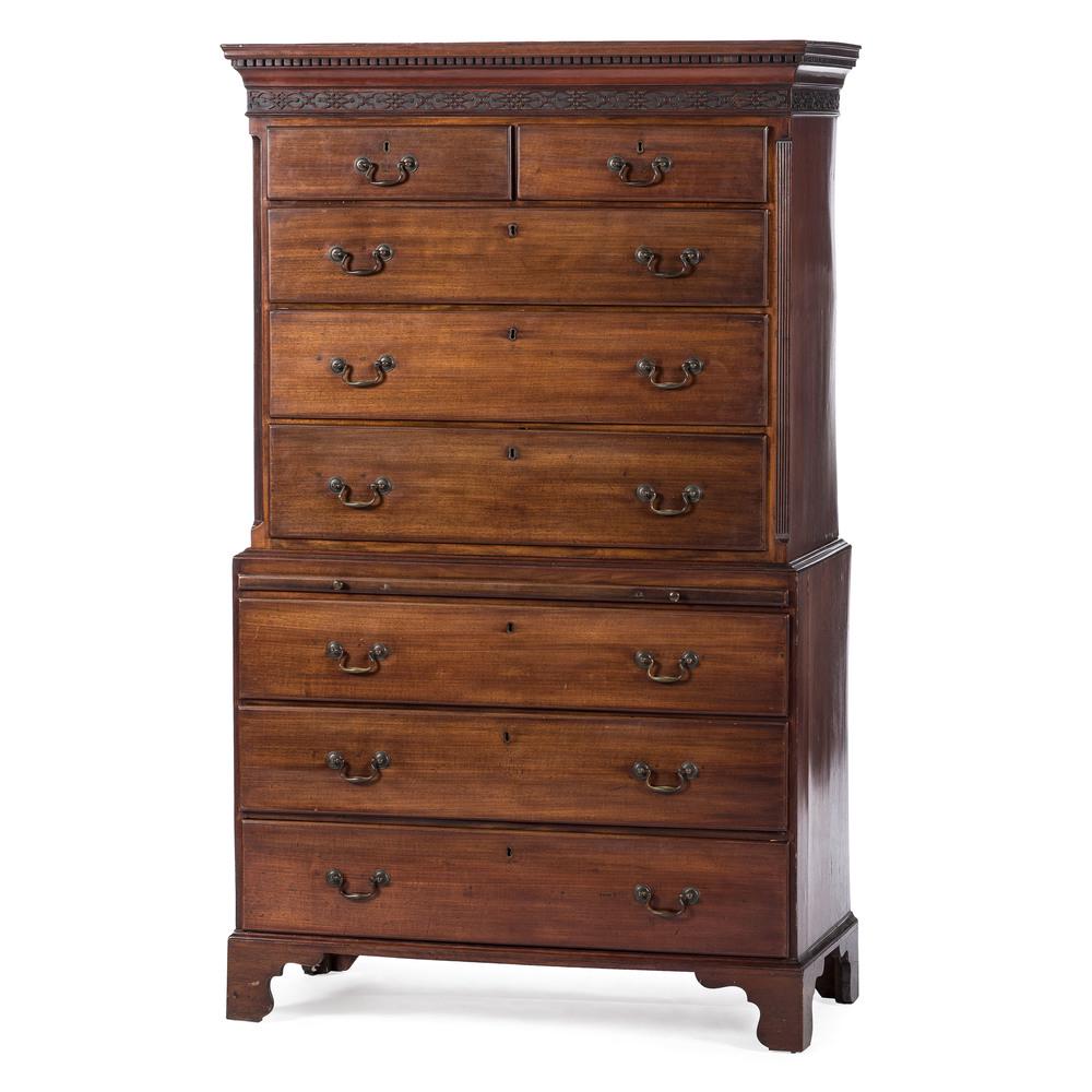 English Chippendale Chest on Chest: English, early 19th century. A Georgian Chippendale chest on chest in mahogany with oak secondary, the upper case having a dentilwork and blind fret cornice, over two aligned and three graduated lap m