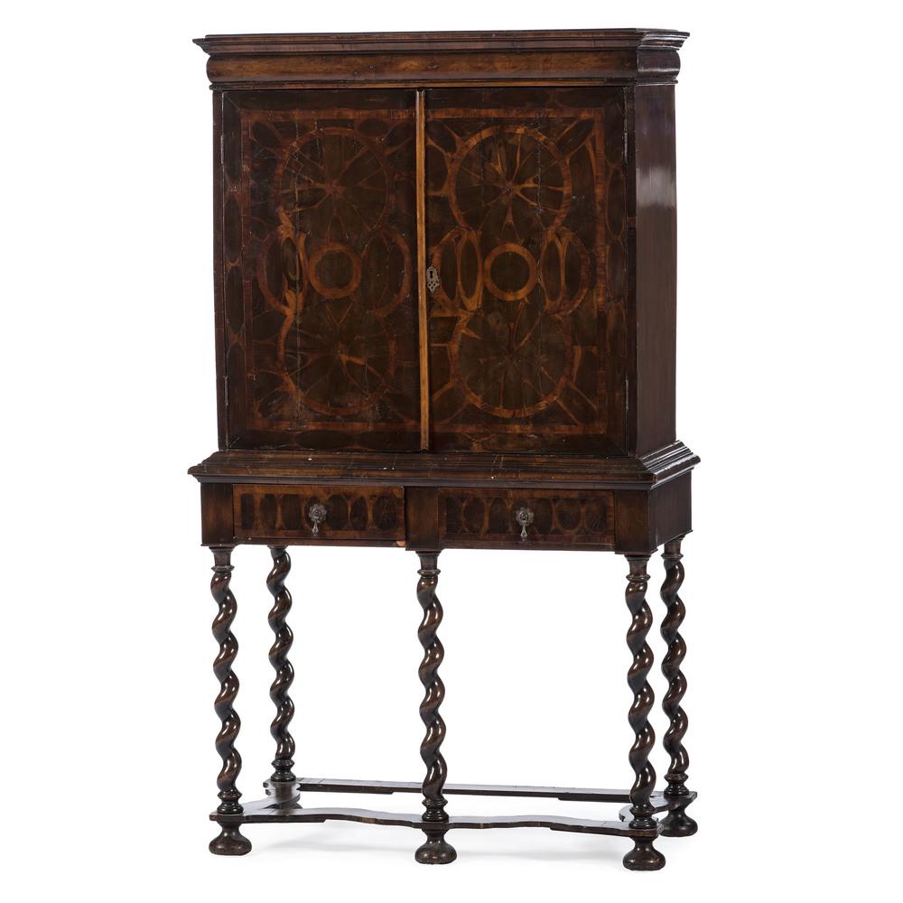 William and Mary Style Chest on Frame: English, 19th century. A William and Mary-style chest on frame in mahogany, having a molded cornice over two inlaid cupboard doors with open interior, the step molded waist above two fitted drawers wi