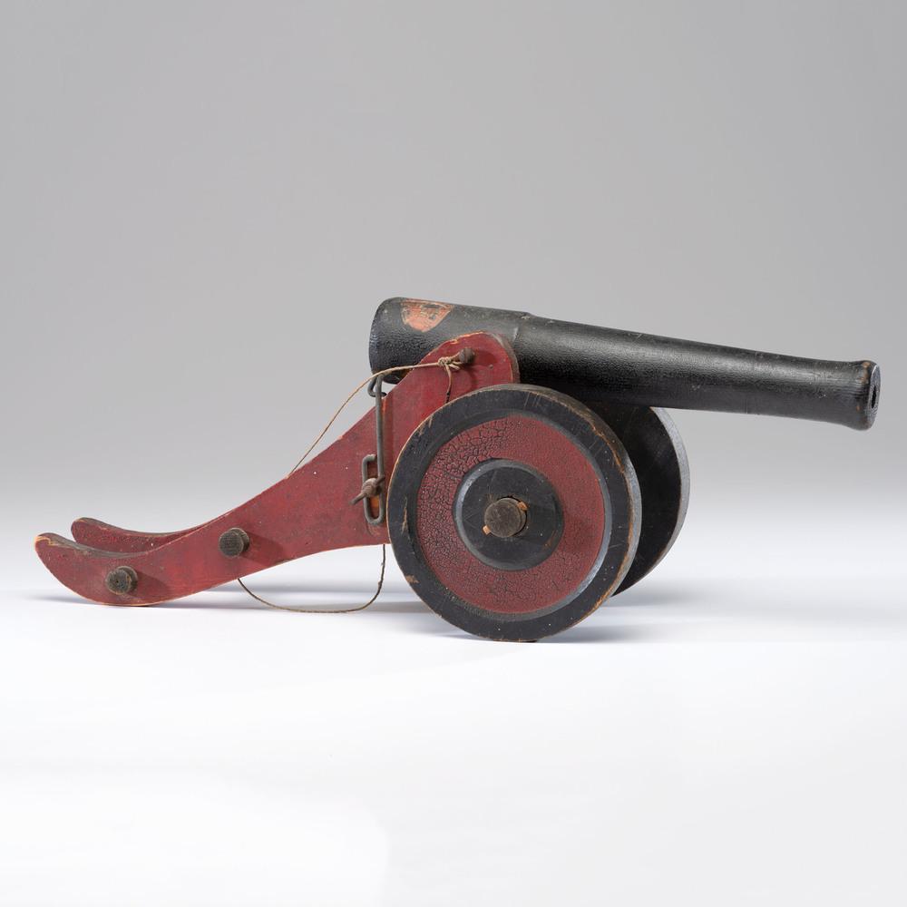 Yankee Boy Toy Cannon: American, first quarter 20th century. A wooden toy cannon by N.O. Fawick Manufacturing Co. of Sioux Falls, South Dakota, in old alligatored paint, with label to the trail and partial label on the barr