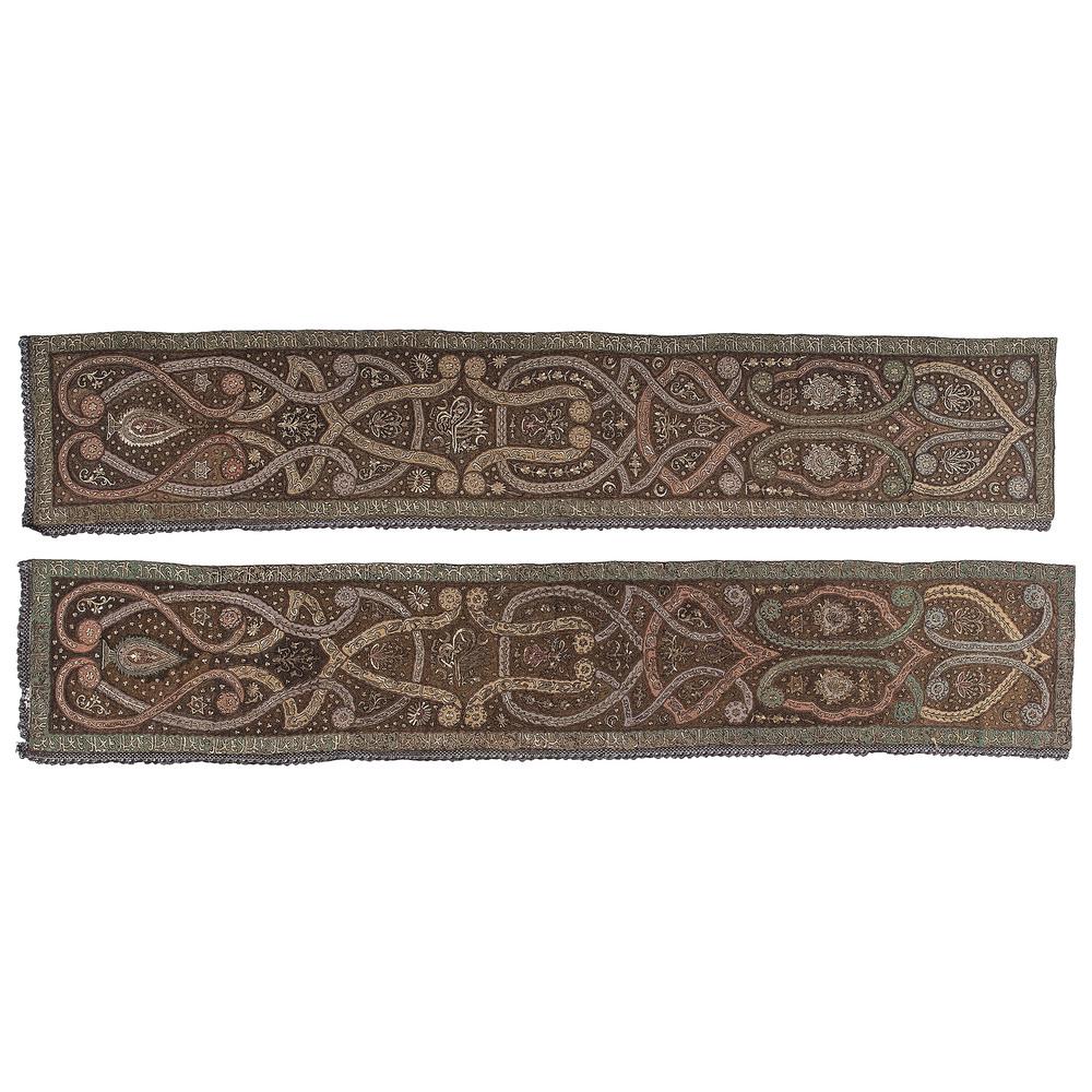 Pair of Turkish Ottoman Silk Embroidered Panels: Turkish, 19th century. A pair of silk hand-embroidered panels with metallic thread, decorated with Islamic motifs and stylized Arabic script, each with fringe on two sides; 120.5 x 21.5 in. (each). 