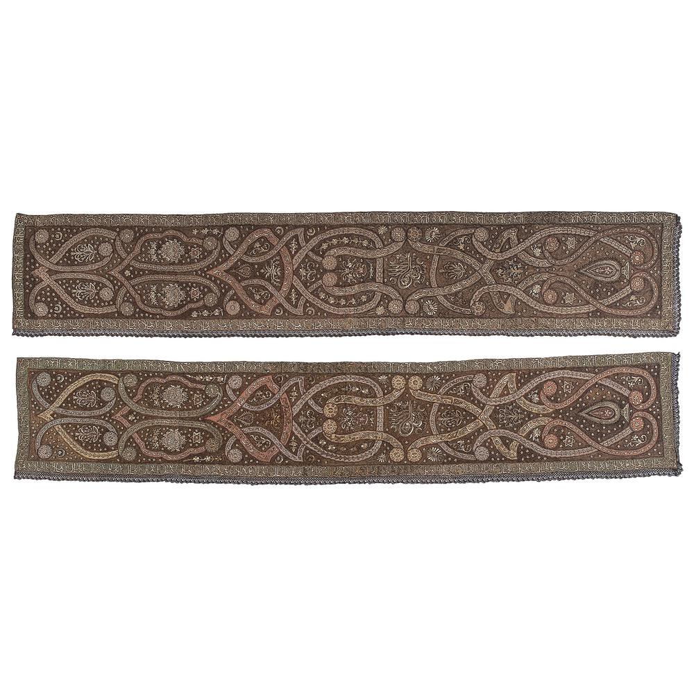Pair of Turkish Ottoman Silk Embroidered Panels: Turkish, 19th century. A pair of silk hand-embroidered panels with metallic thread, decorated with Islamic motifs and stylized Arabic script, each with fringe on two sides; 120.5 x 21.5 in. (each). 
