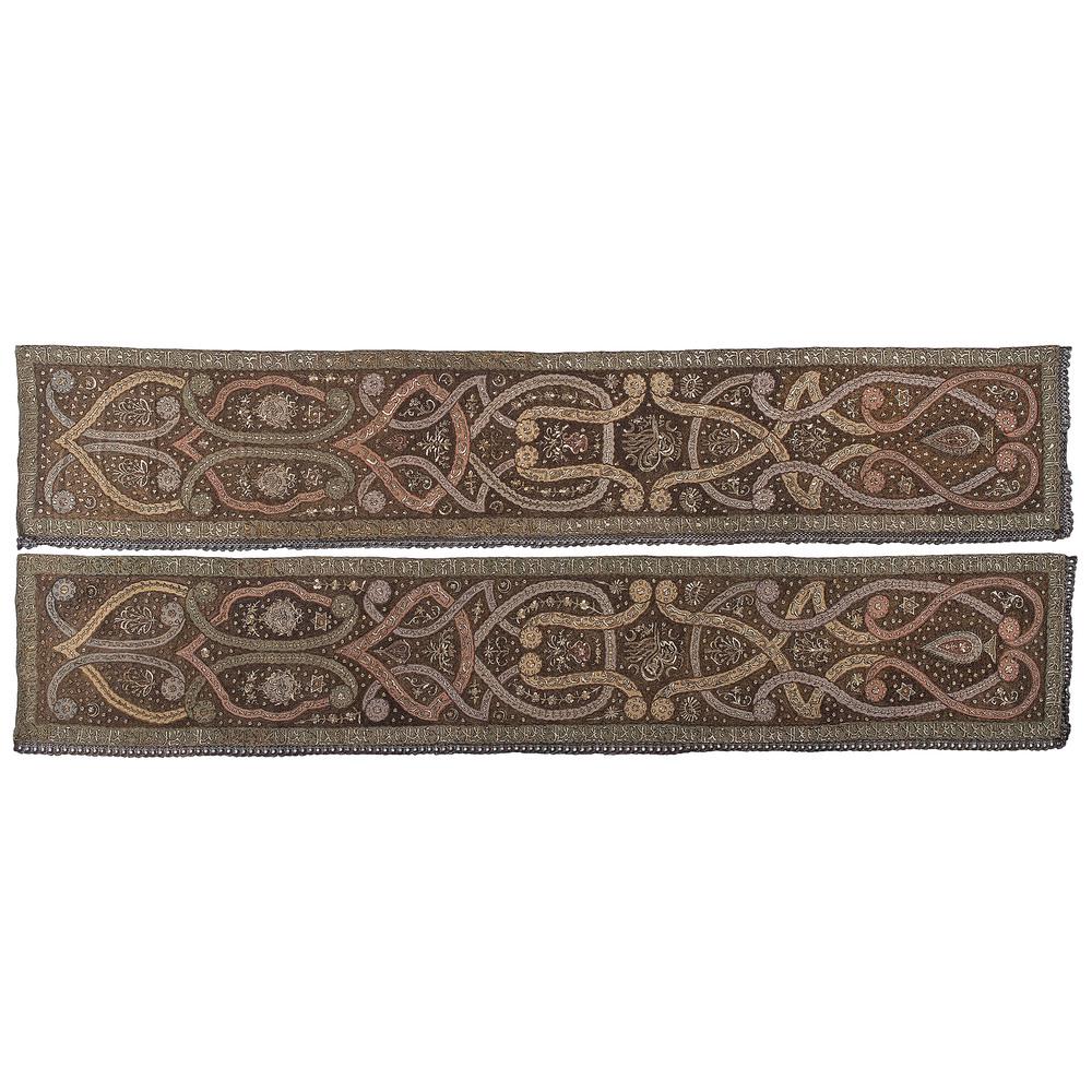 Pair of Turkish Ottoman Silk Embroidered Panels: Turkish, 19th century. A pair of silk hand-embroidered panels with metallic thread, decorated with Islamic motifs and stylized Arabic script, each with fringe on two sides; 120.5 x 21.5 in. (each). 