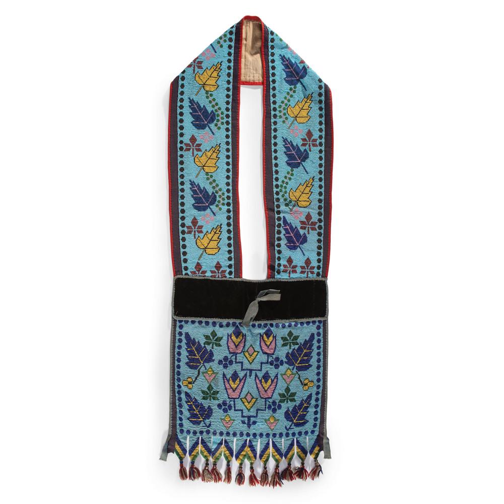 Potawatomi Loom Beaded Bandolier Bag: decorated with maple leaves and stylized flowers on panel and strap; light blue beaded background and decorations in colors of yellow, dark blue, black, mauve, and yellow; red, tan, and blue wool frin