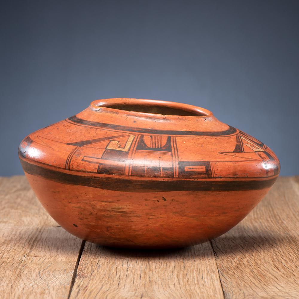 Hopi Polychrome Redware Pottery Jar, From the Stanley: designed with stylized eagle tails and painted geometrics, height 5.25 in. x diameter 10 in. early 20th century Provenance: From the Stanley Slocum Collection, Minnesota