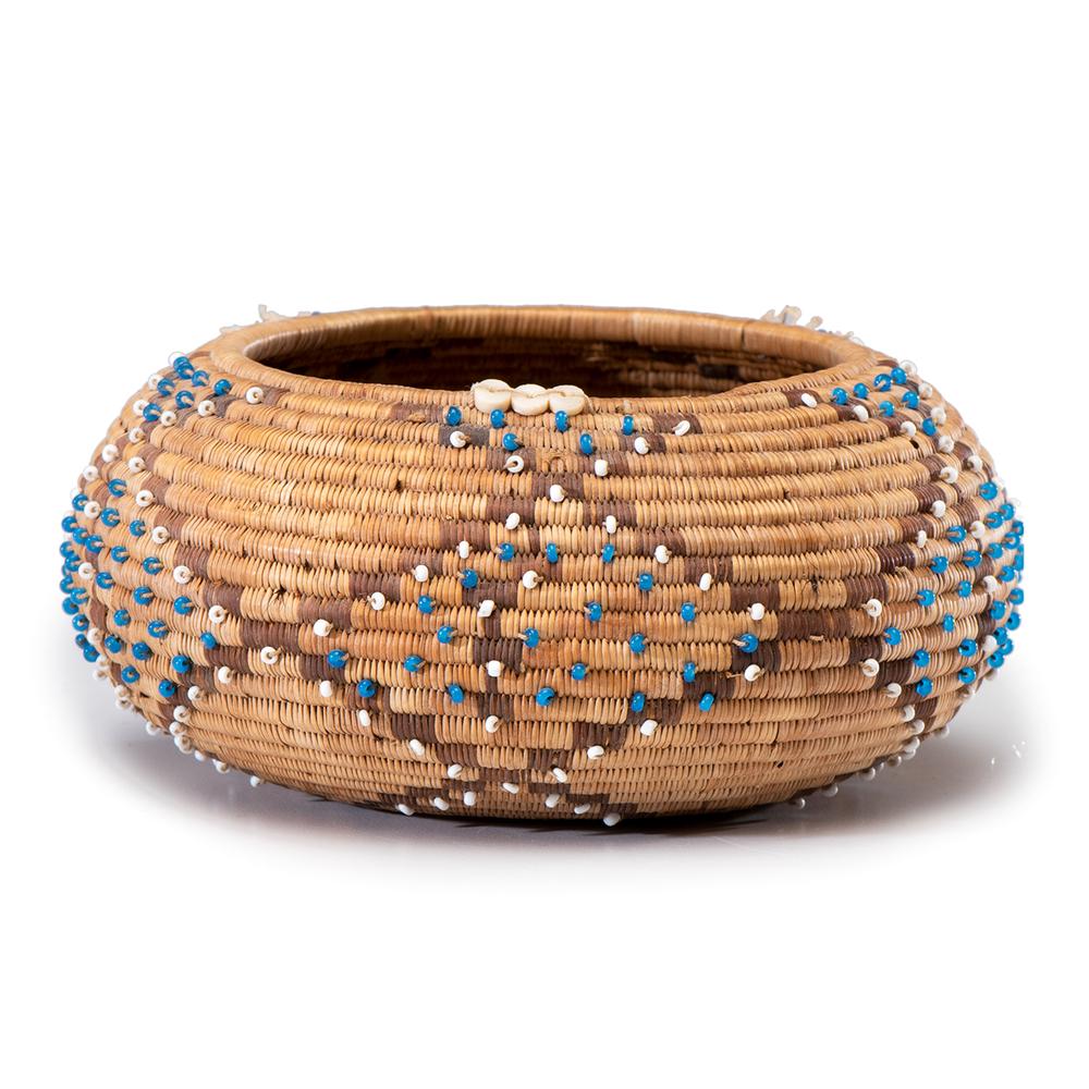 Pomo Beaded Gift Basket: squat circular form with geometric designs accentuated with blue and white beads; height 2.25 in. x diameter 5 in. early 20th century