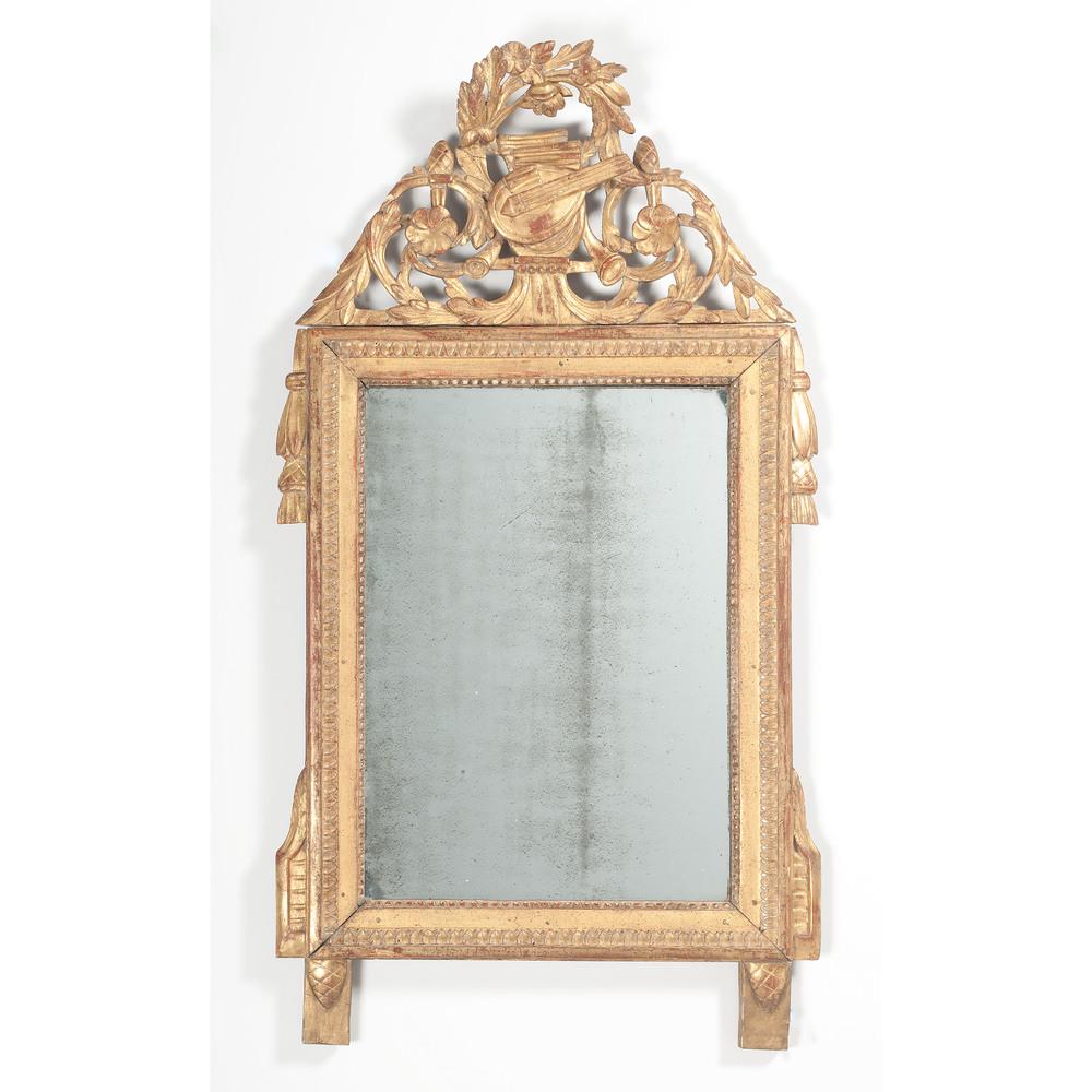 French Giltwood Mirror: French, mid-19th century. A giltwood mirror with carved and pierced crest having musical motifs; ht. 45.25, wd. 24.5 in. Provenance: Property from Donald A. Rich Interiors and Antiques, New Canaan, Co