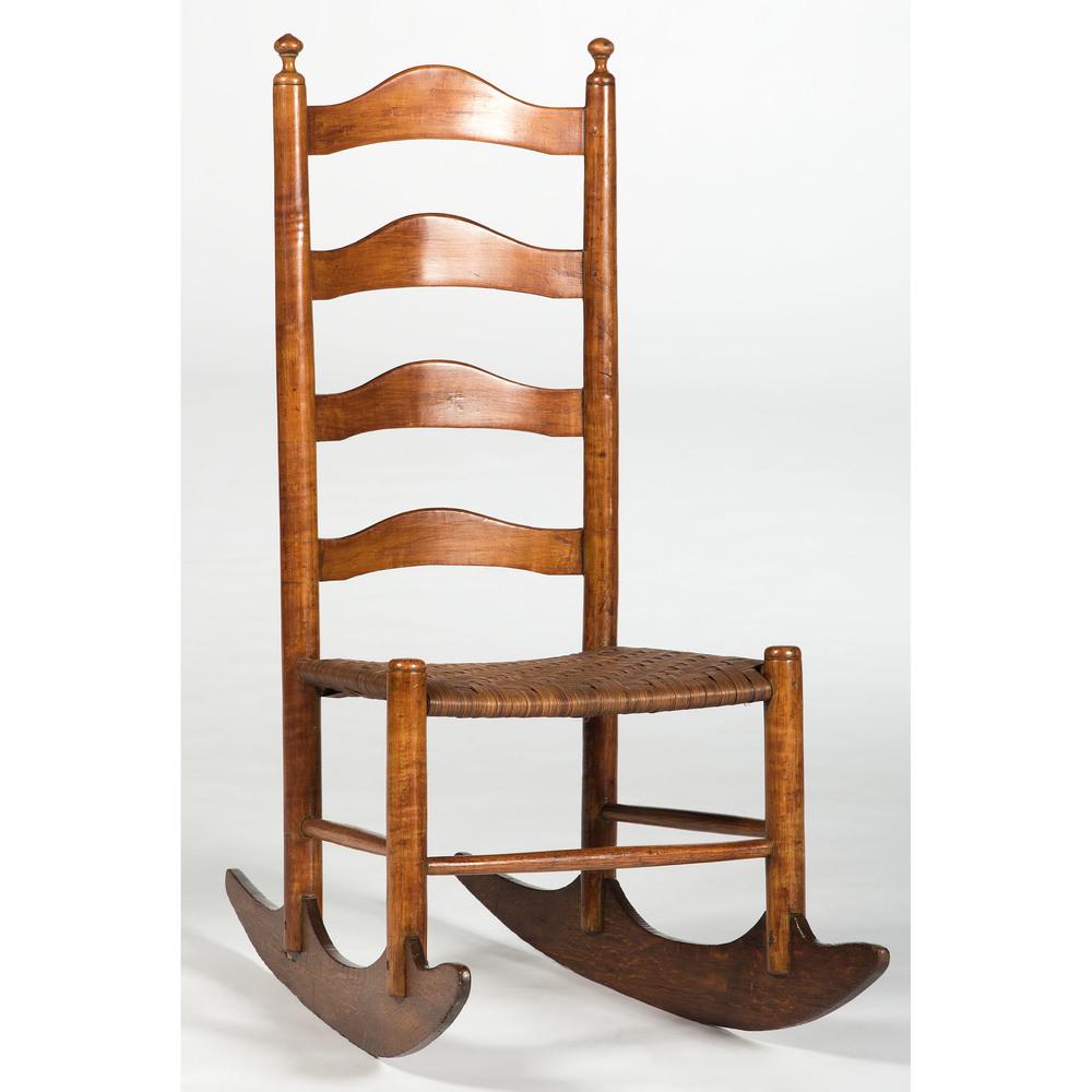Ladderback Rocker: American, 19th century. A ladderback rocker in maple, having four horizontal splats over rattan seating, the stiles with turned finials, rising on shaped rockers; ht. 38, wd. 16, dp. 30 in. Provenan