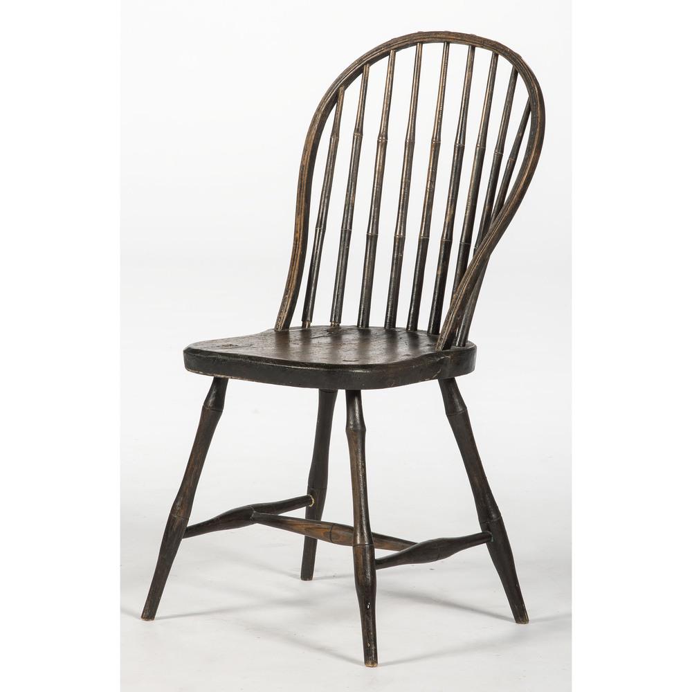 Painted Windsor Chair: American, early 19th century. A bow back Windsor side chair in black paint, having a shaped frame with bamboo nine-spindle back, over a plank seat and rising on bamboo turned legs and stretcher; ht. 3