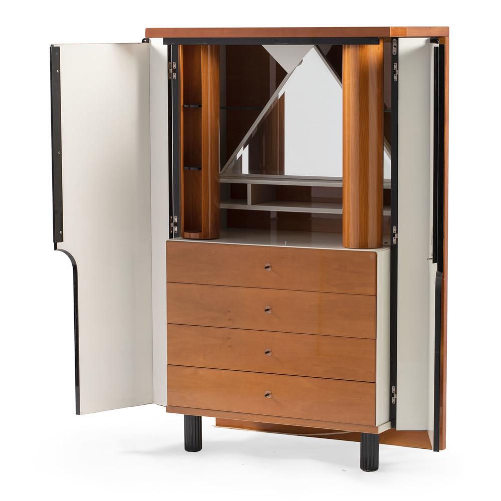 Maurice Villency Vanity Dresser: American, 20th century. A Maurice Villency vanity dresser with two black lacquer doors that open to reveal a vanity and four drawers. The interior vanity has two rotating pillars with storage, plus a