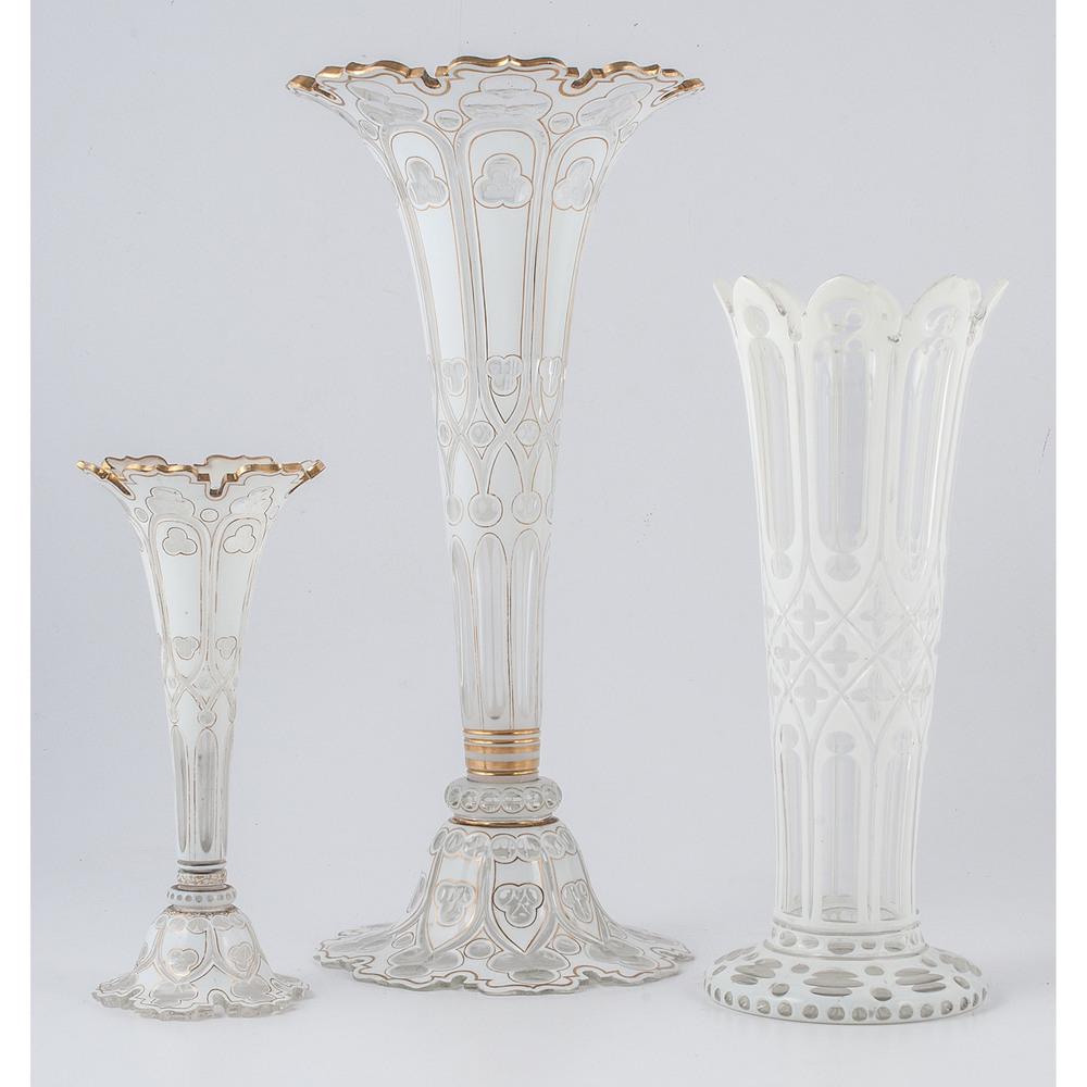 White Cut-to-Clear Glass Vases: American, late 19th-early 20th century. Three white cut-to-clear glass vases, including two trumpet vases of different sizes with gold paint, and one vase without paint; largest ht. 16.25, dia. 7.75 i