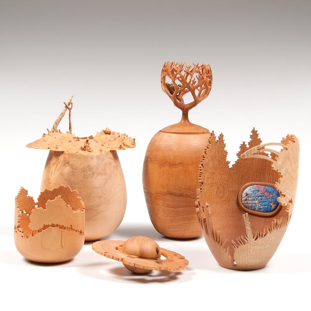 Tom Rauschke (American, 20th Century) Wooden: American, late 20th-early 21st century. A group of four wooden sculptures by Tom Rauschke, including a small dish with undulating forest, pierced at the trunks, signed and dated '00 on underside, a s
