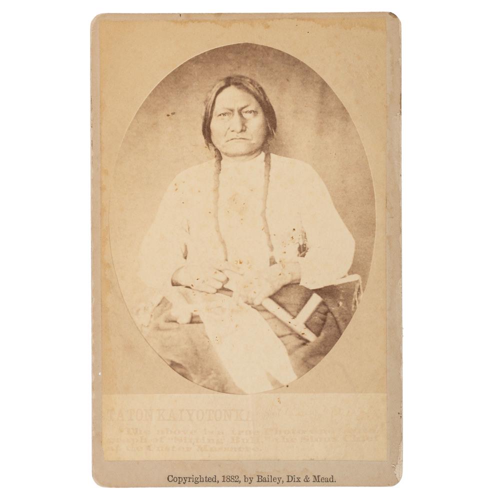 Sitting Bull Cabinet Card by Bailey, Dix & Mead: Cabinet card of Sitting Bull holding Plains-style pipe, with "Copyright, 1882, by Bailey, Dix & Mead" imprint on mount recto, plus "No. 1. Sitting Bull and True Autograph" printed with a brief biograp