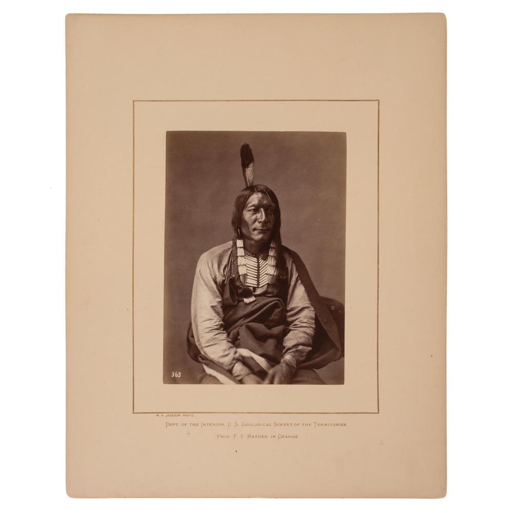 Alexander Gardner Albumen Photograph of Wicked Bear: Alexander Gardner Albumen Photograph of Wicked Bear, Brulé Lakota Albumen photograph, 5.25 x 7.25 in., on 11 x 14 in. Hayden Survey mount with credit at lower left to W.H. Jackson. Studio view of Bru