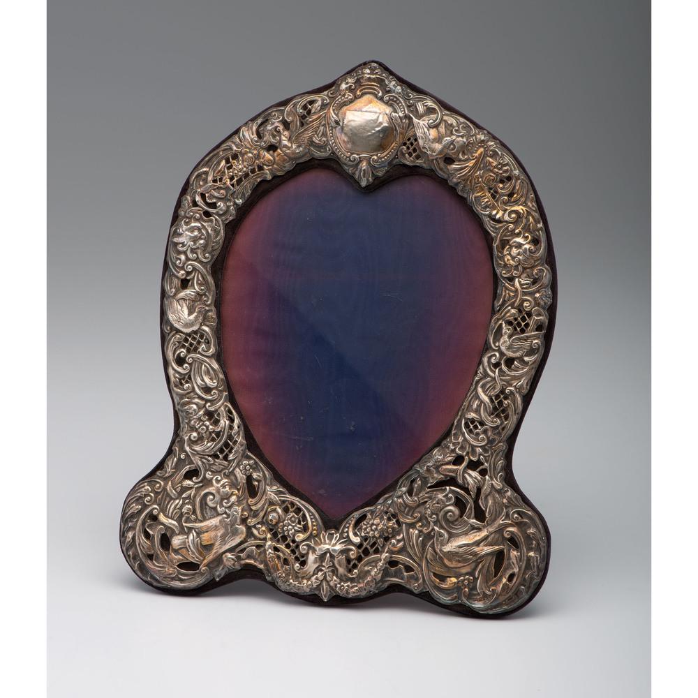 English Silver Mounted Heart Mirror: English, 20th century. A Keyford Frames silver-mounted mirror, with hallmarks lower right; ht. 13.25, wd. 10.25 in.