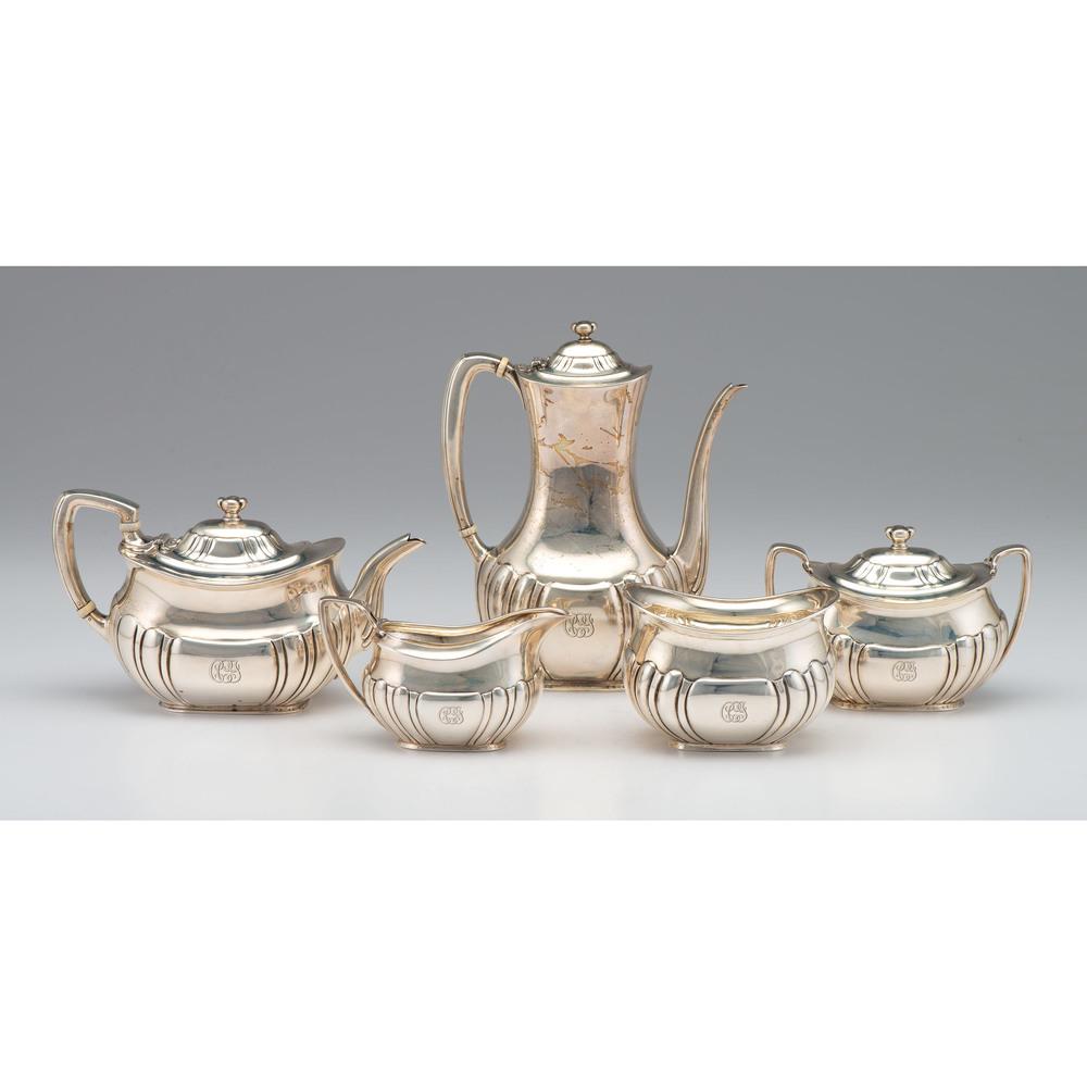Tiffany & Co. Sterling Tea and Coffee Service: American, first half 20th century. A five-piece sterling tea and coffee service by Tiffany & Co., including a tea pot, coffee pot, creamer, sugar, and waste bowl. Each piece marked on underside, inclu