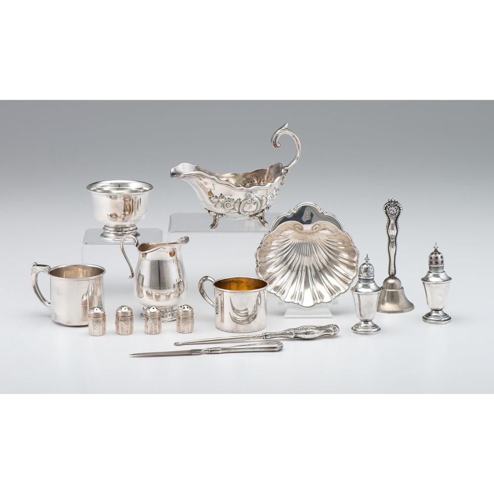 Sterling Silver Tablewares and Accessories, Plus: 20th century. A group of sterling accessories by various makers including six shakers, two child's mugs and a bowl, a creamer, a shell dish, and a bell, file and button hook with sterling handles, PLU