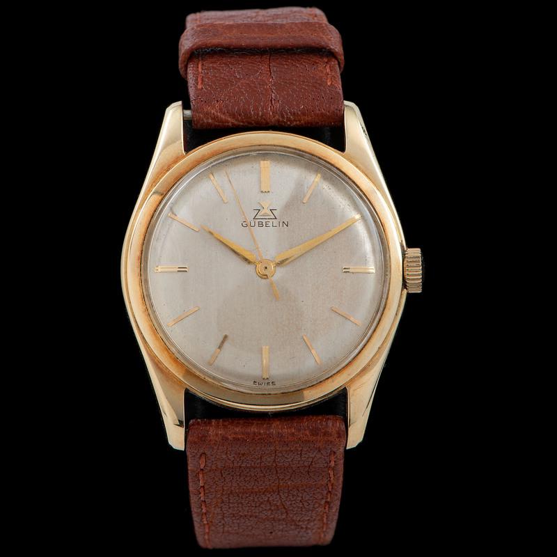 Gubelin 14k Gold Wrist Watch: Gubelin 14k Gold Wrist Watch Gubelin 14k Gold Wrist Watch champagne dial, 34 mm 14k gold case, movement marked: GUBELIN SWISS TWENTYONE 21 JEWELS, case interior marked: GUBELIN SWISS 14K 585 4/10 1643