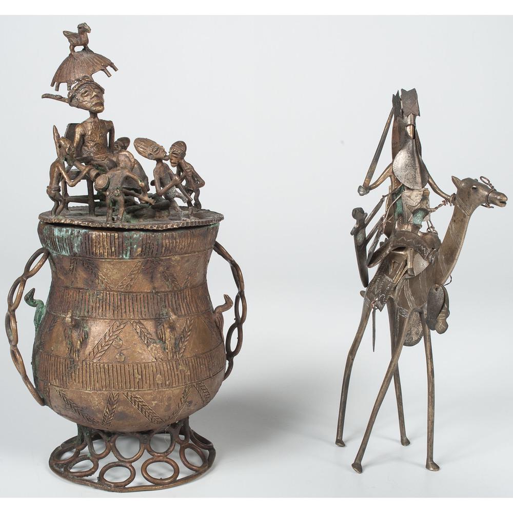 African Kuduo Vessel, Plus: African Kuduo Vessel, Plus 20th century. A copper kuduo vessel with figural lid and incised bowl, PLUS a metal armored figure on camel back, with punched decoration; vessel oah. 11.25 in., figure oah.