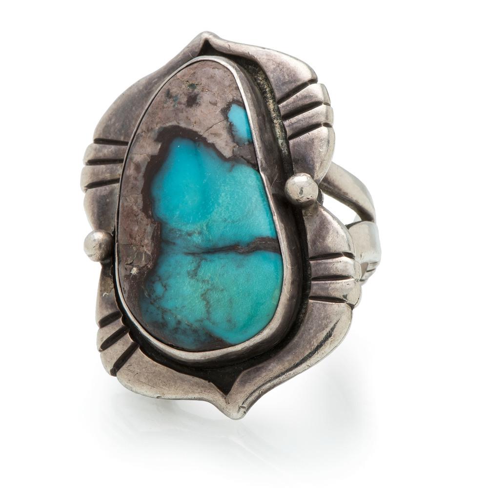 Preston Monongye (Hopi, 1927-1987) Silver and Turquoise: Preston Monongye (Hopi, 1927-1987) Silver and Turquoise Ring with a large turquoise cabochon; marked with the thunderbird hallmark of Preston Monongye, size 11.25, face length 1.75 in., weight 116.4 d