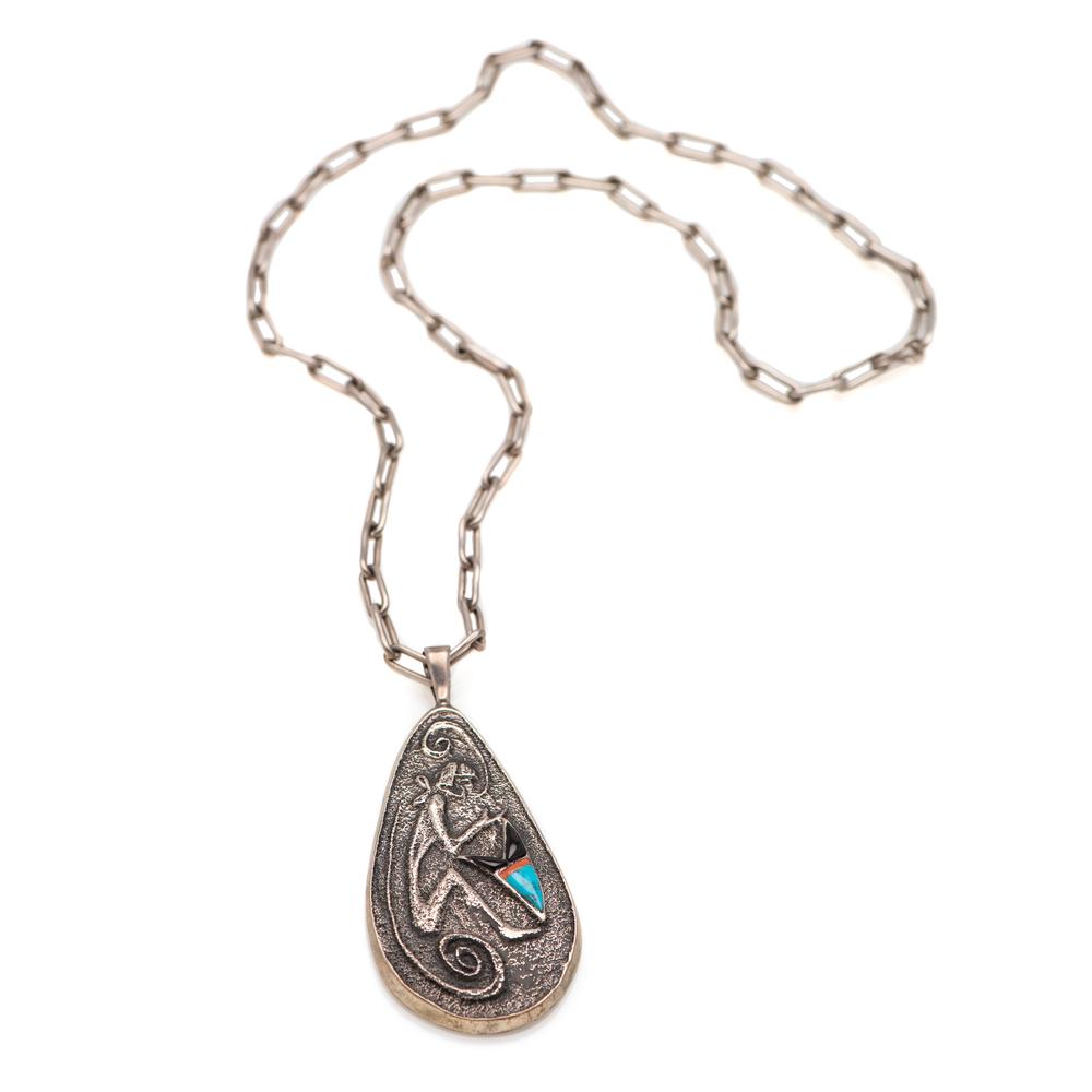 Preston Monongye (Hopi, 1927-1987) Tufa Cast Silver: Preston Monongye (Hopi, 1927-1987) Tufa Cast Silver Pendant with Turquoise Cabochon teardrop-shaped tufa cast pendant featuring a snake dancer figure and a singular offset turquoise cabochon; strung o