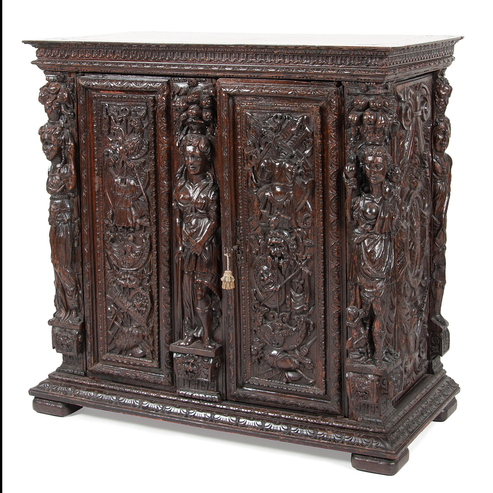 Italian Renaissance Cupboard in Walnut: Italian Renaissance Cupboard in Walnut Italian, 17th century and later. A Renaissance cupboard in walnut, having molded top over heavily carved case with figural and heraldic motif, with two doors, al