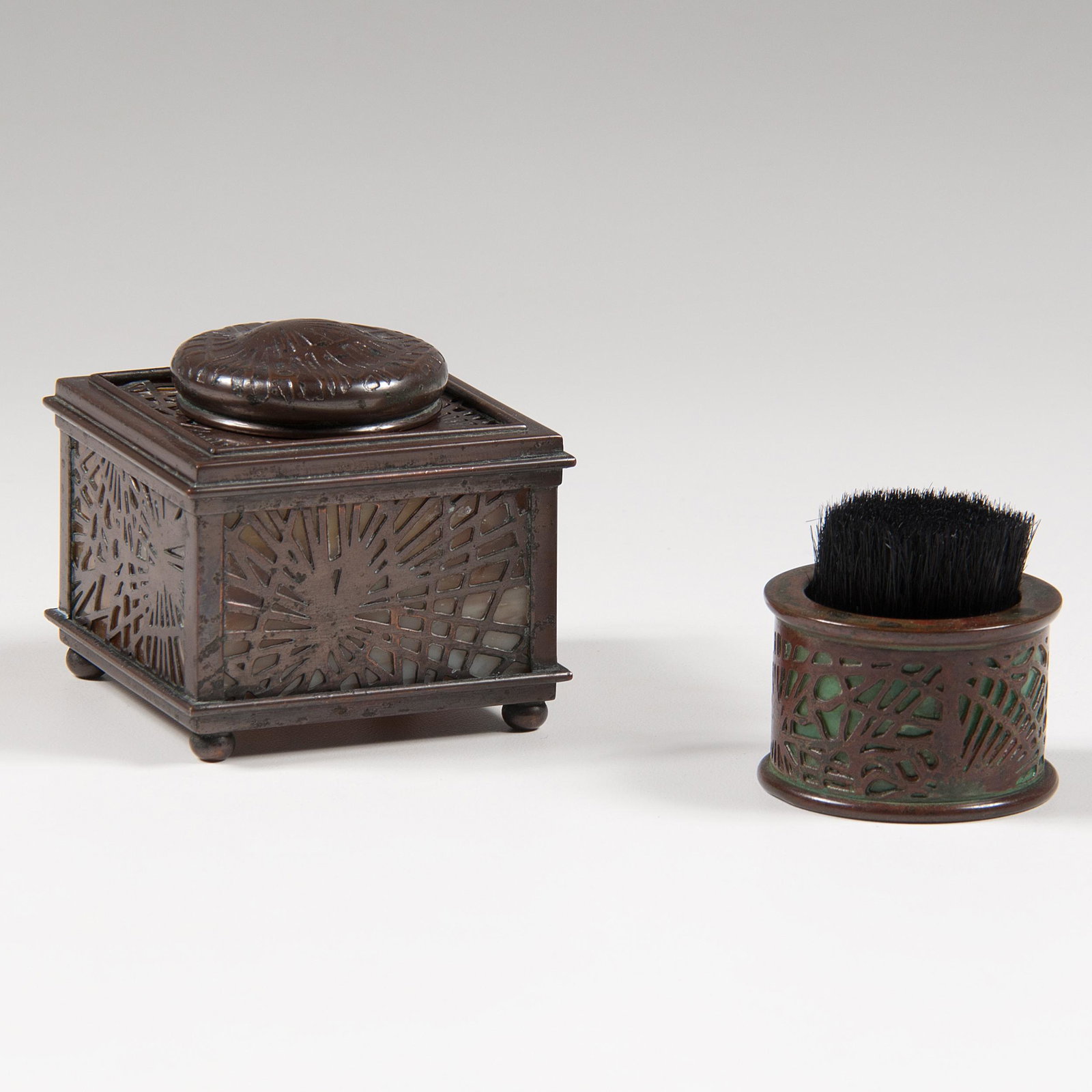 Tiffany Studios Pine Needle Inkwell and Pen Wipe: Tiffany Studios Pine Needle Inkwell and Pen Wipe American, early 20th century. Two Tiffany Studios desk accessories in pine needle pattern, including a number 845 inkwell with cream-colored glass, an