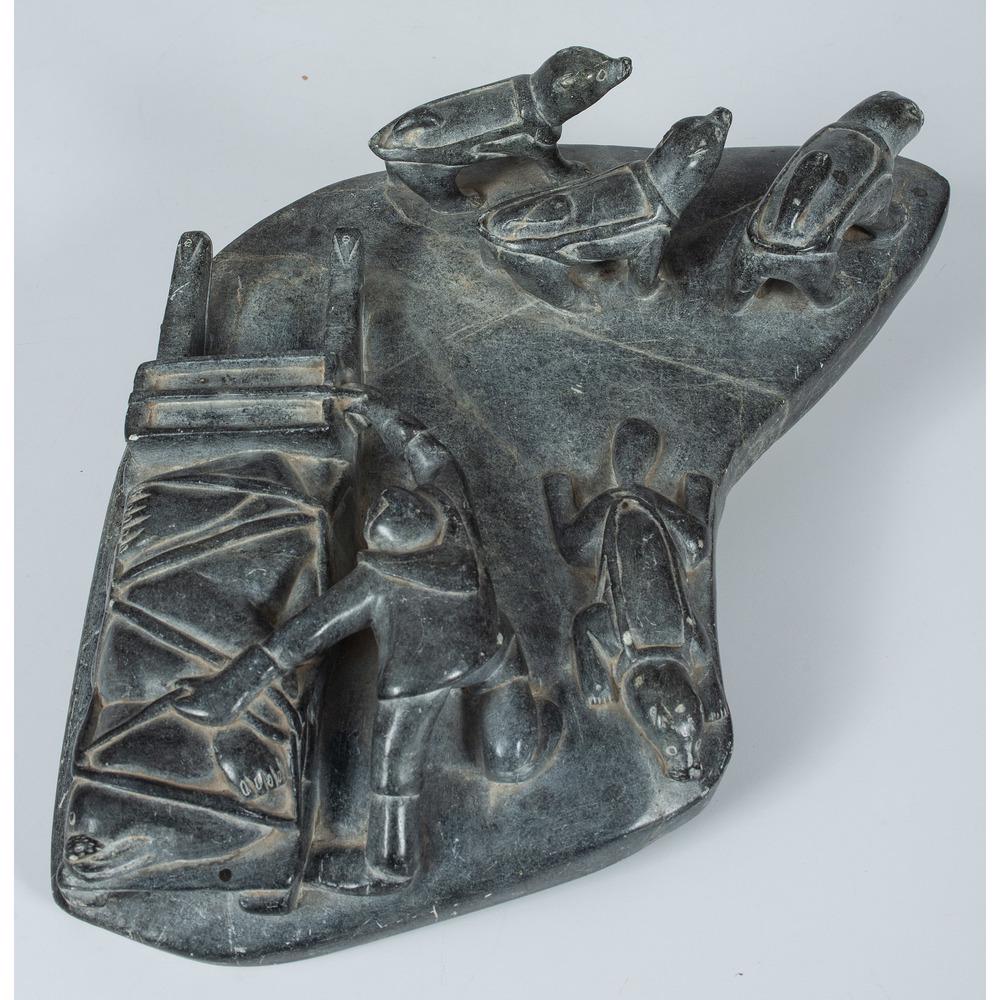 Jimmy Inaruli Arnamissak (Inuit, 1946-2003) Soapstone: Jimmy Inaruli Arnamissak (Inuit, 1946-2003) Soapstone Sled Dog Carving depicts three dogs, walrus tied to sled, man grabbing the sled, and otter, signed on base with name and disc number, height 3 in.