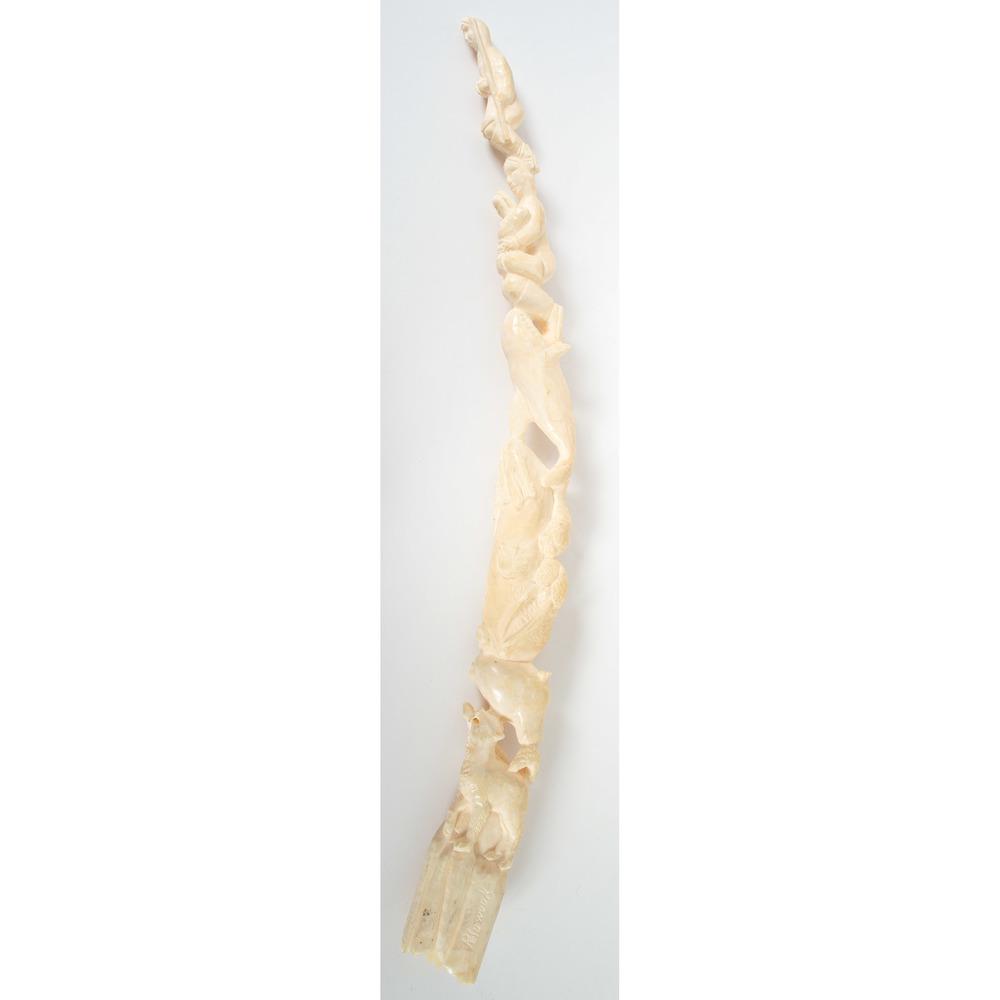 Inuit Figural Carving: Inuit Figural Carving carved with Inuit man, woman with child, Orca whale, walrus, seal, wolf, and eagle, signed Pelowook; length 19.5 in. third quarter 20th century