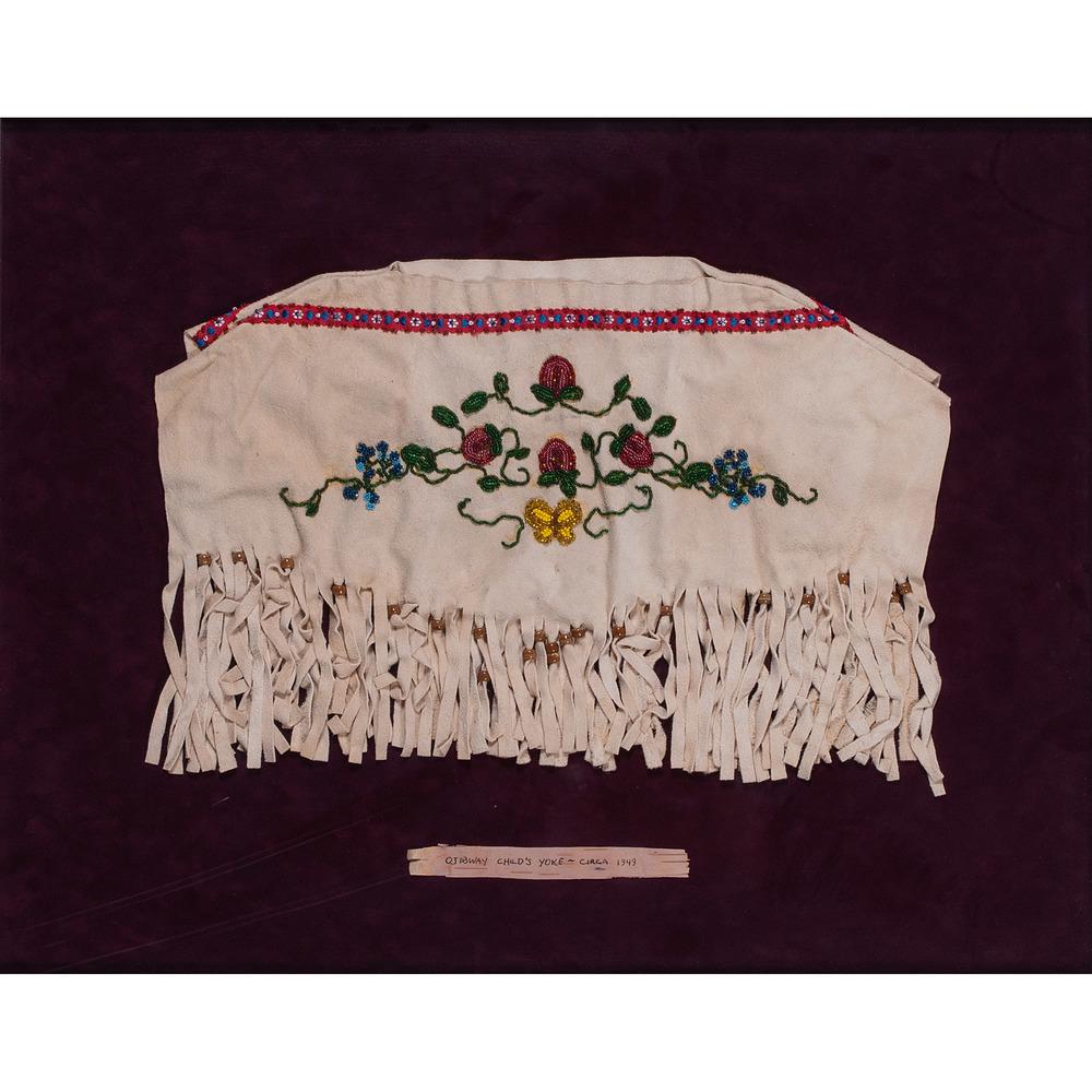 Anishinaabe Beaded Hide Child's Dress Yoke: thread-sewn and beaded in translucent green, rose, and amber; design depicts strawberries and a butterfly, width 20 in. x height 12 in., yoke is framed, 27 x 33 in. mid-20th century