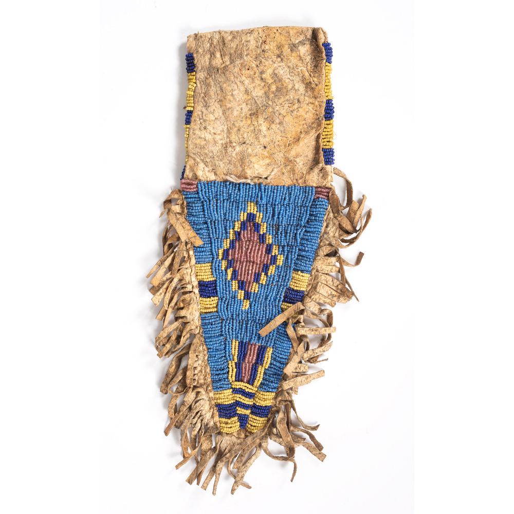 Central Plains Beaded Tab Pouch: beaded on hide with fringe; geometric patterns beaded in colors of light blue, blue, yellow, and pearly red; length with fringe 11.5 in. x width 3.75 in. ca 1900 Provenance: From the Stanley B. Sloc