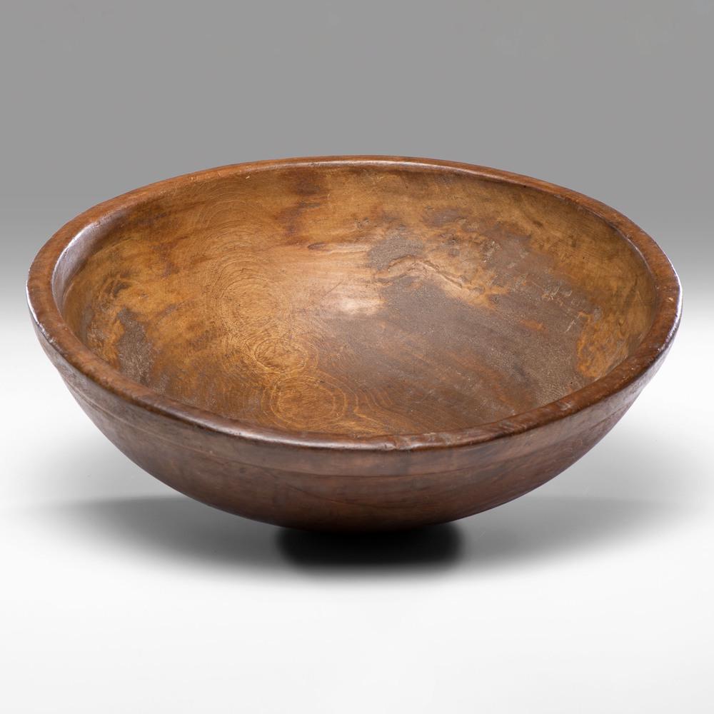 A Turned Walnut Bowl: A Turned Walnut Bowl 19th Century Height 6 1/2 x diameter 18 1/2 inches. Property from the Collection of Judith & Gary Gay, Morrow, Ohio