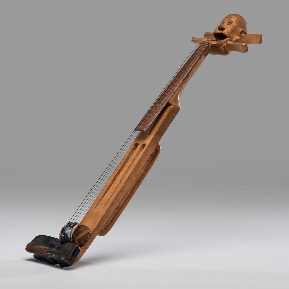 A Carved Folk Art Stringed Instrument: A Carved Folk Art Stringed Instrument Length 24 inches. Purported to be from the Mendelsohn Collection of folk art.